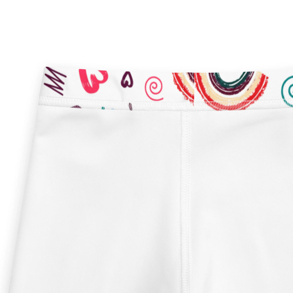 White girls leggings with colorful rainbow swirls and heart waistband perfect for playful everyday wear