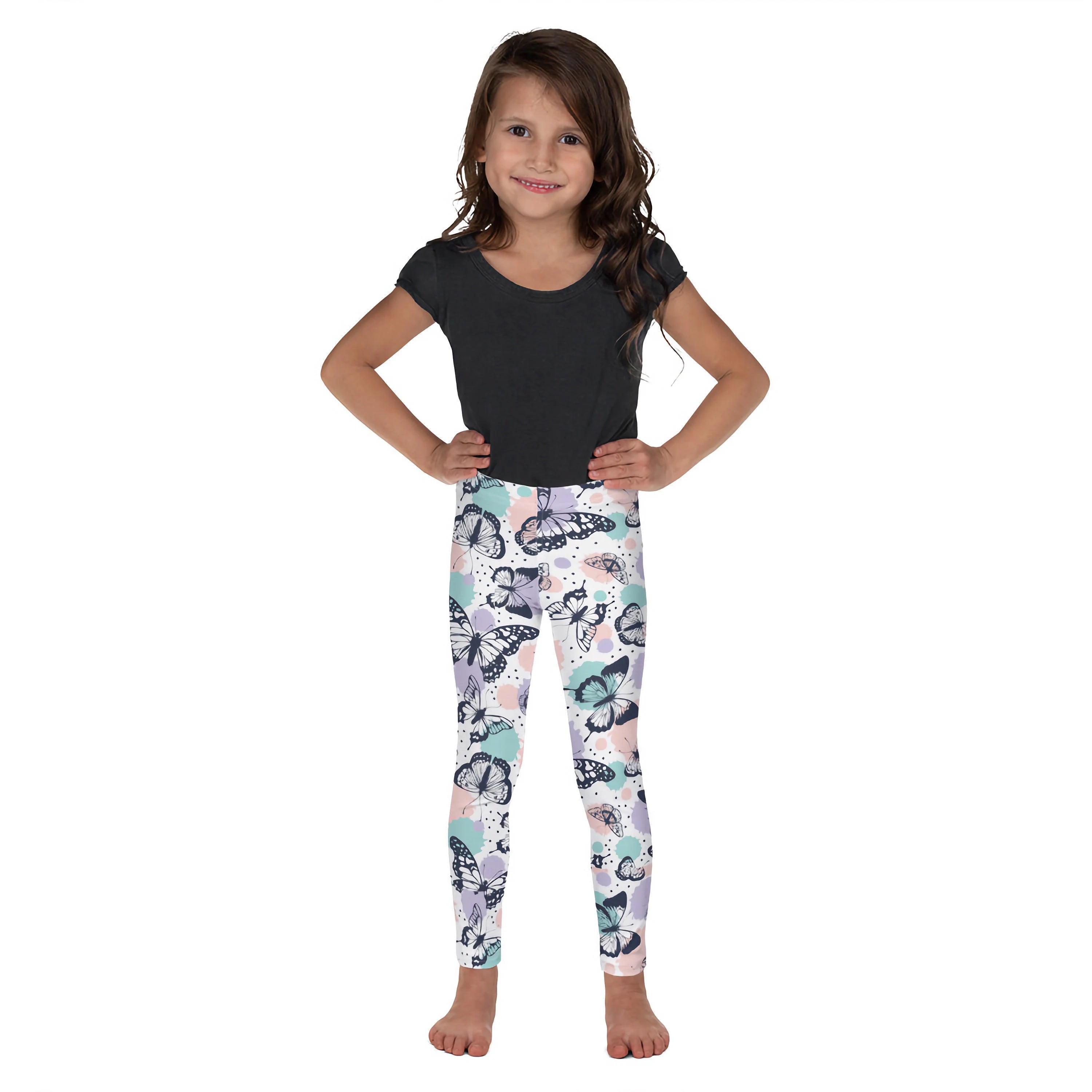 A child wearing girls butterfly buttery soft leggings with pastel butterfly pattern and black outlines