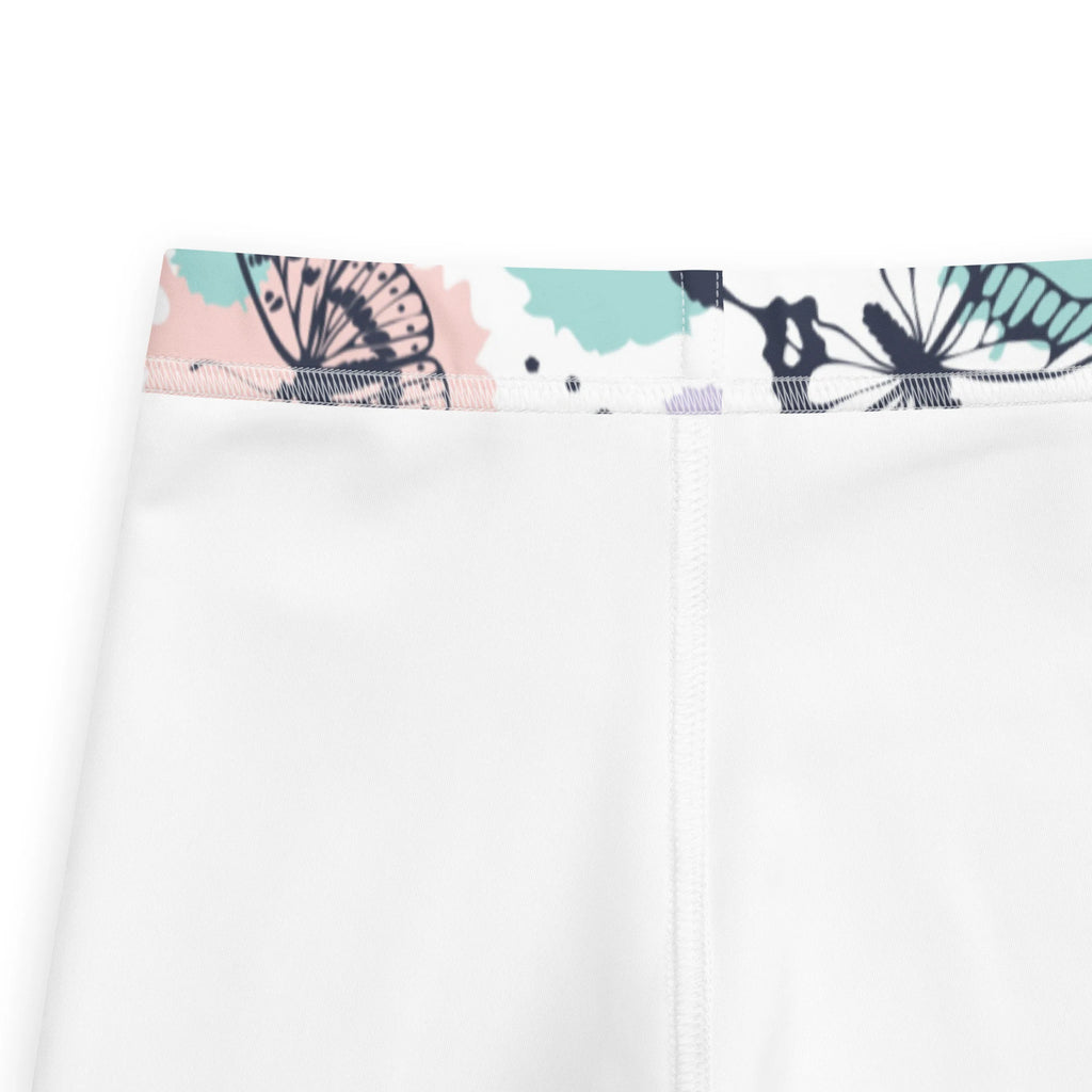 White girls butterfly buttery soft leggings with decorative waistband featuring black butterfly prints on pink teal background