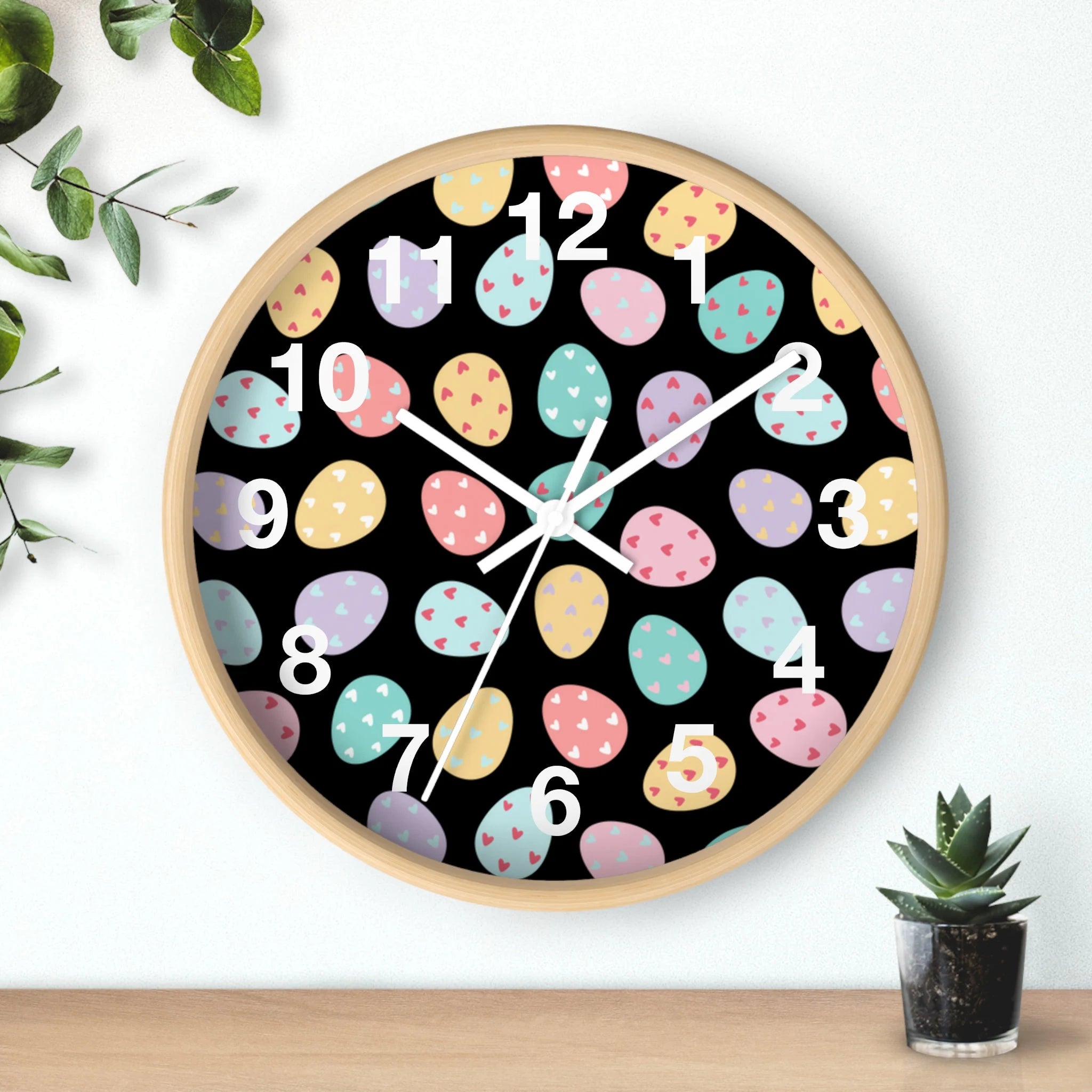 Easter eggs silent wood wall clock with light wood frame black face and colorful pastel Easter egg design