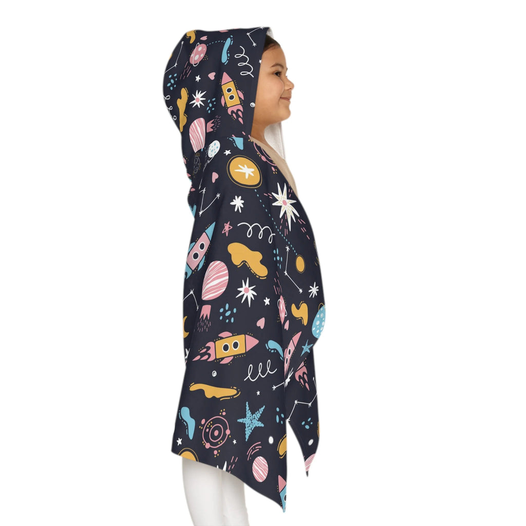 A child wears a dark navy kids outer space hooded towel with colorful rockets planets and stars soft and absorbent wrap