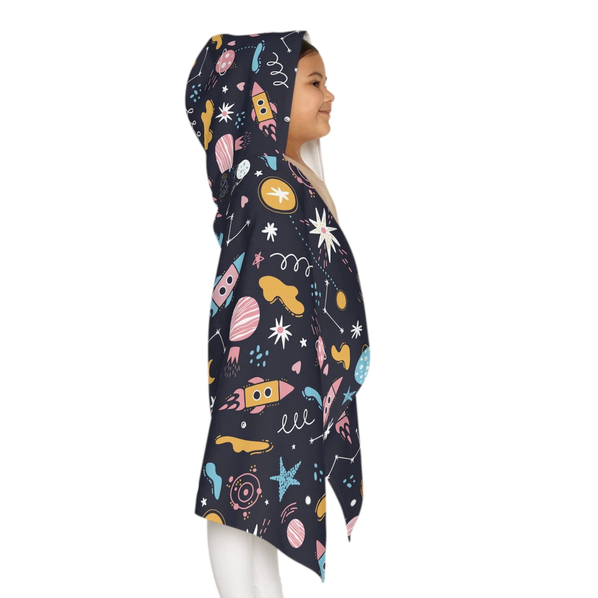 A child wears a dark navy kids outer space hooded towel with colorful rockets planets and stars soft and absorbent wrap