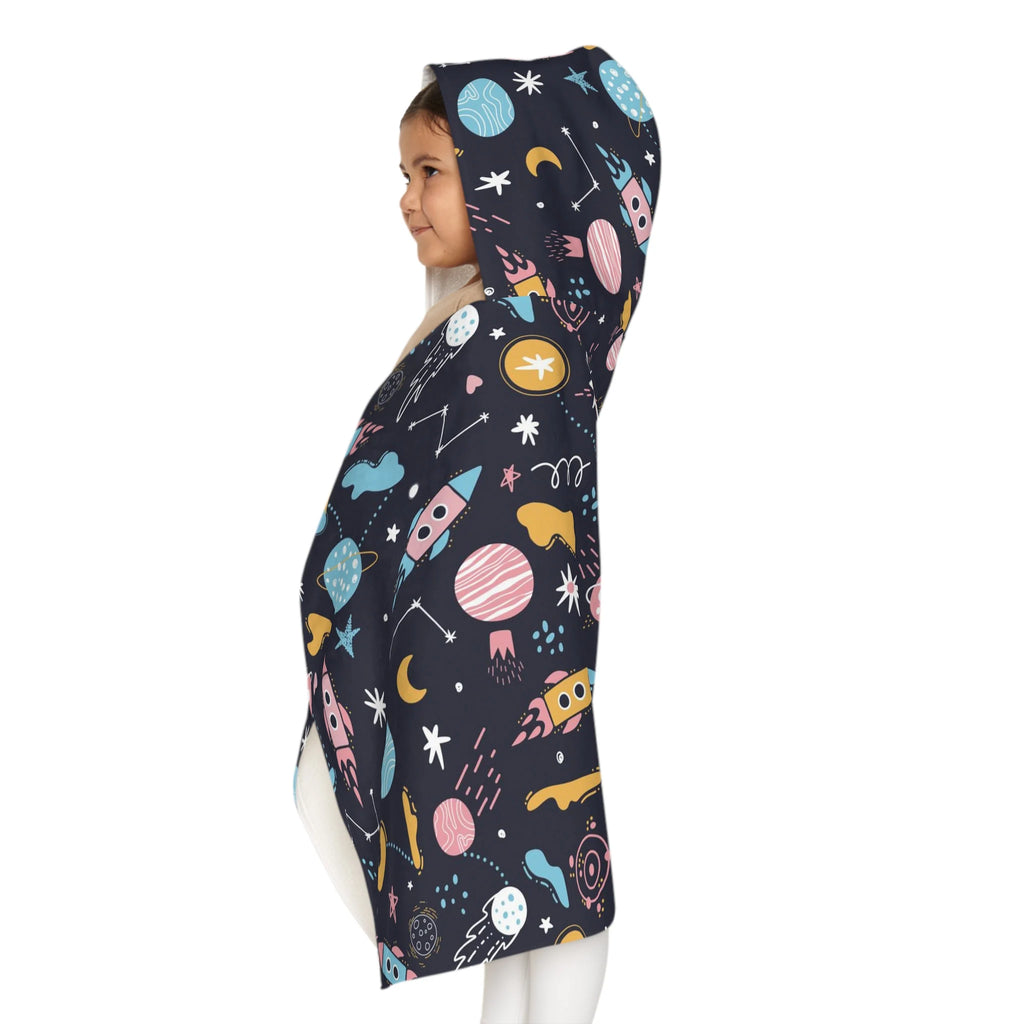 A child wears a dark navy kids outer space hooded towel with colorful cartoon planets and rockets soft and absorbent wrap