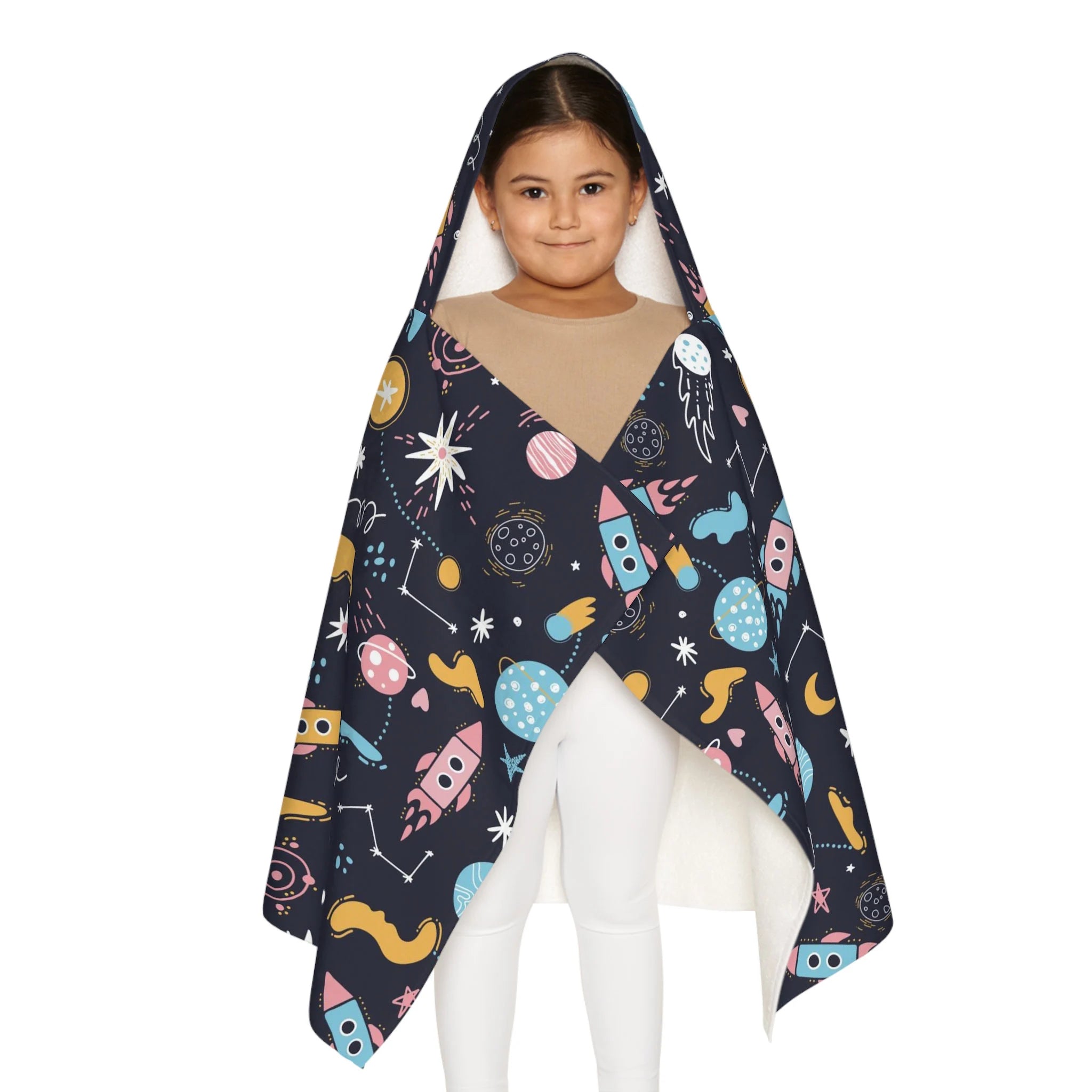 A child wearing a dark navy kids outer space hooded towel with colorful rocket and planet prints soft and absorbent wrap