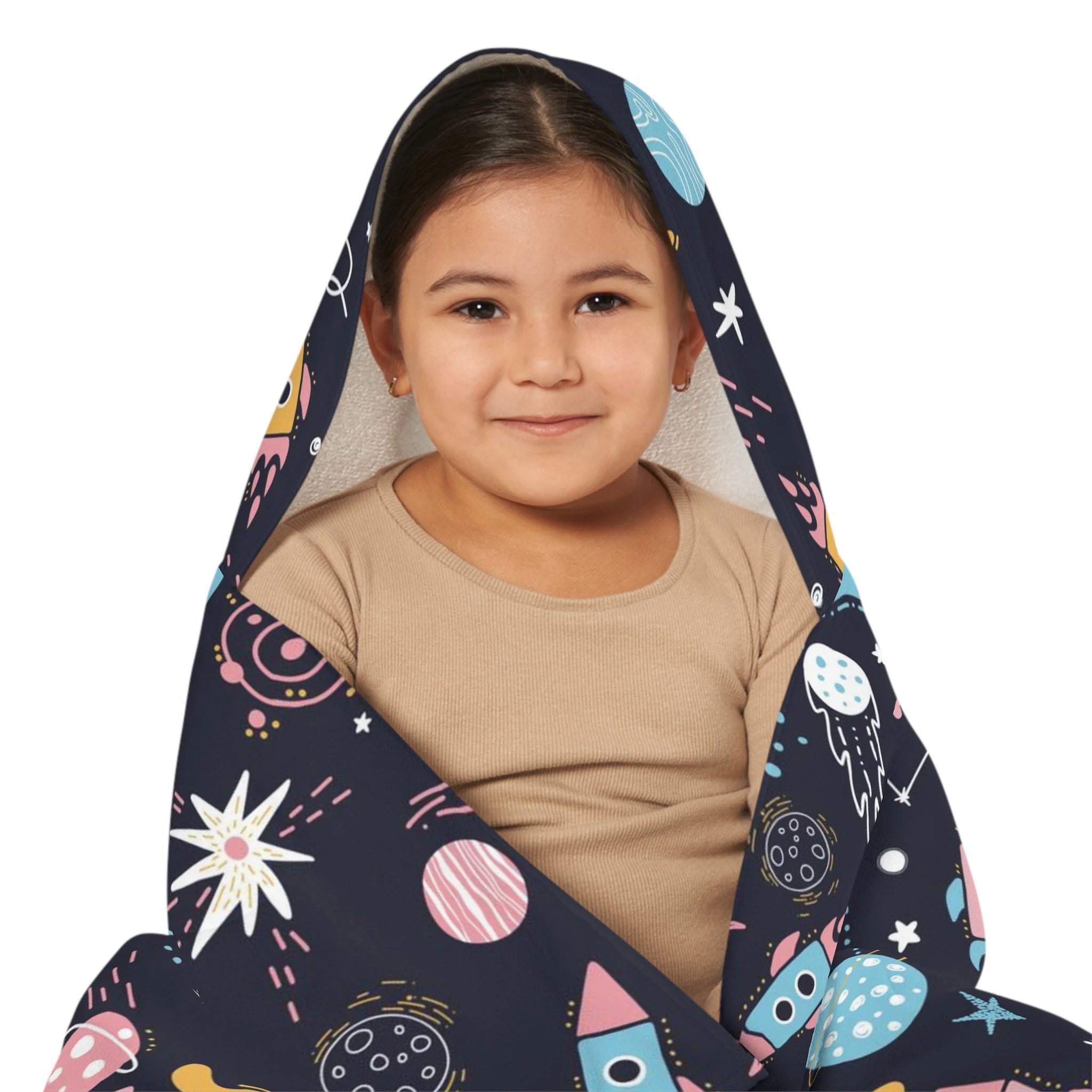 A child wrapped in a soft dark blue kids outer space hooded towel with colorful planets rockets and stars
