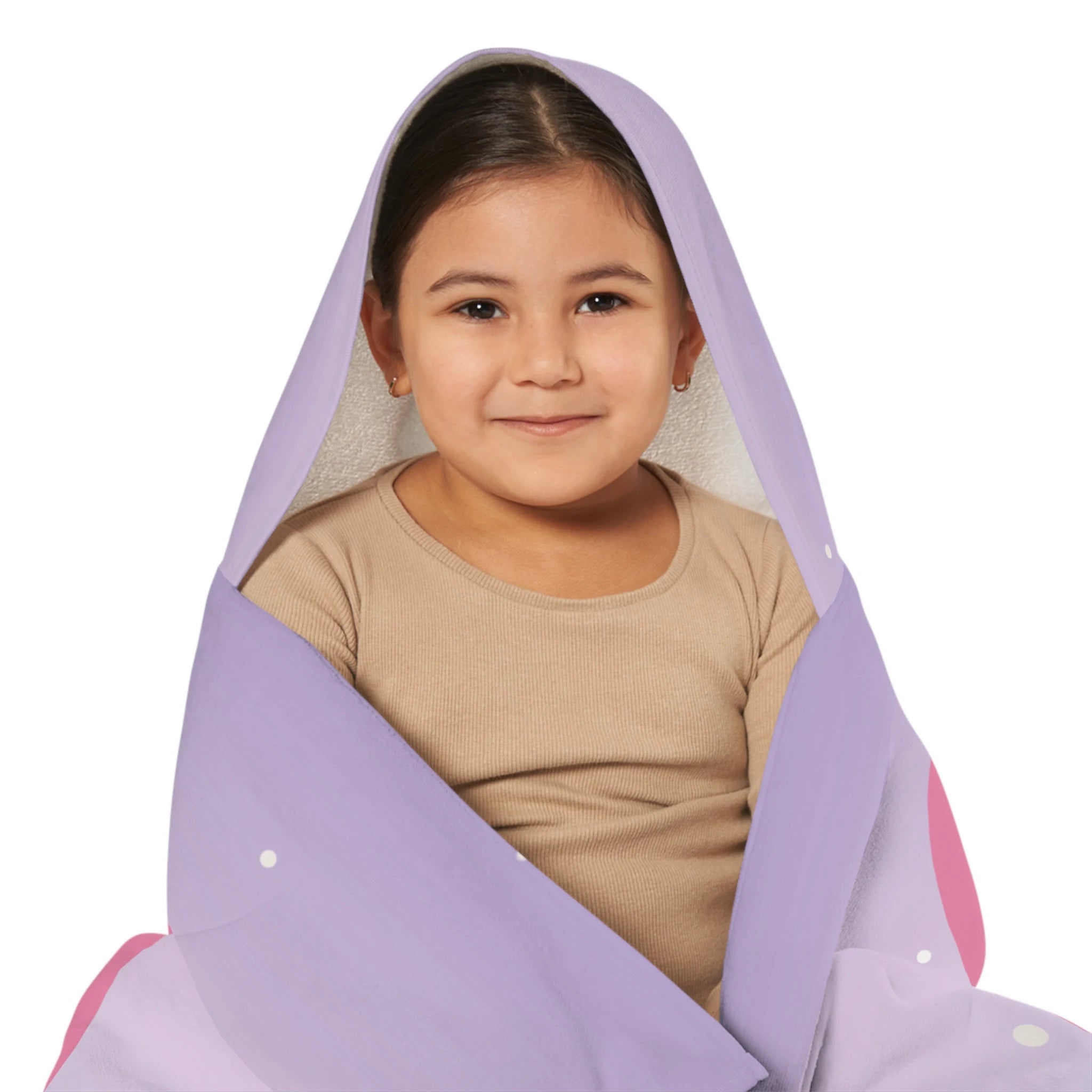 A soft lavender hooded towel with pink accents and white polka dots wrapped snugly around a child for bath or beach use
