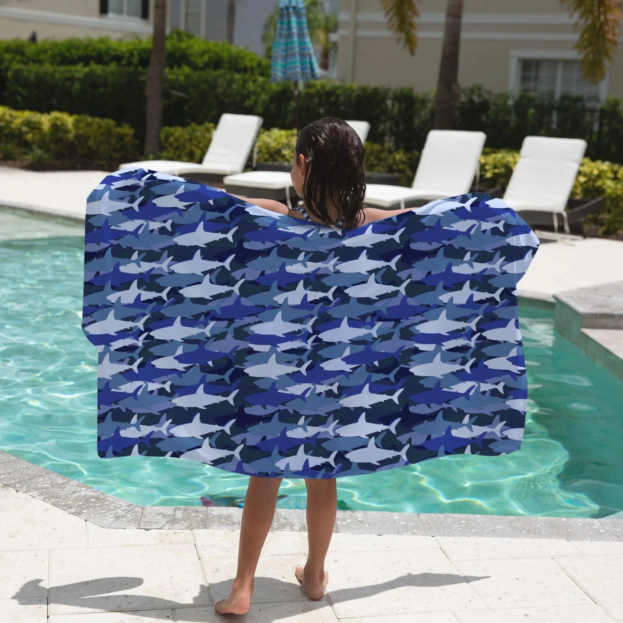Kids blue shark towel made of soft fabric with blue and white shark pattern for beach and pool use