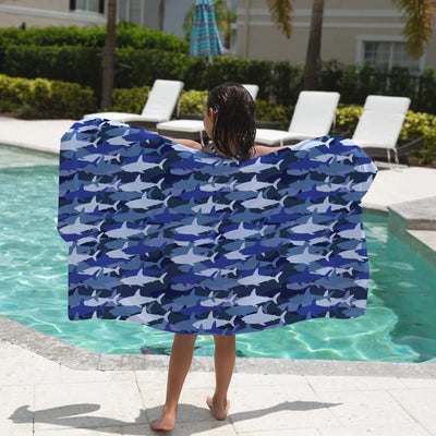 Kids blue shark towel made of soft fabric with blue and white shark pattern for beach and pool use