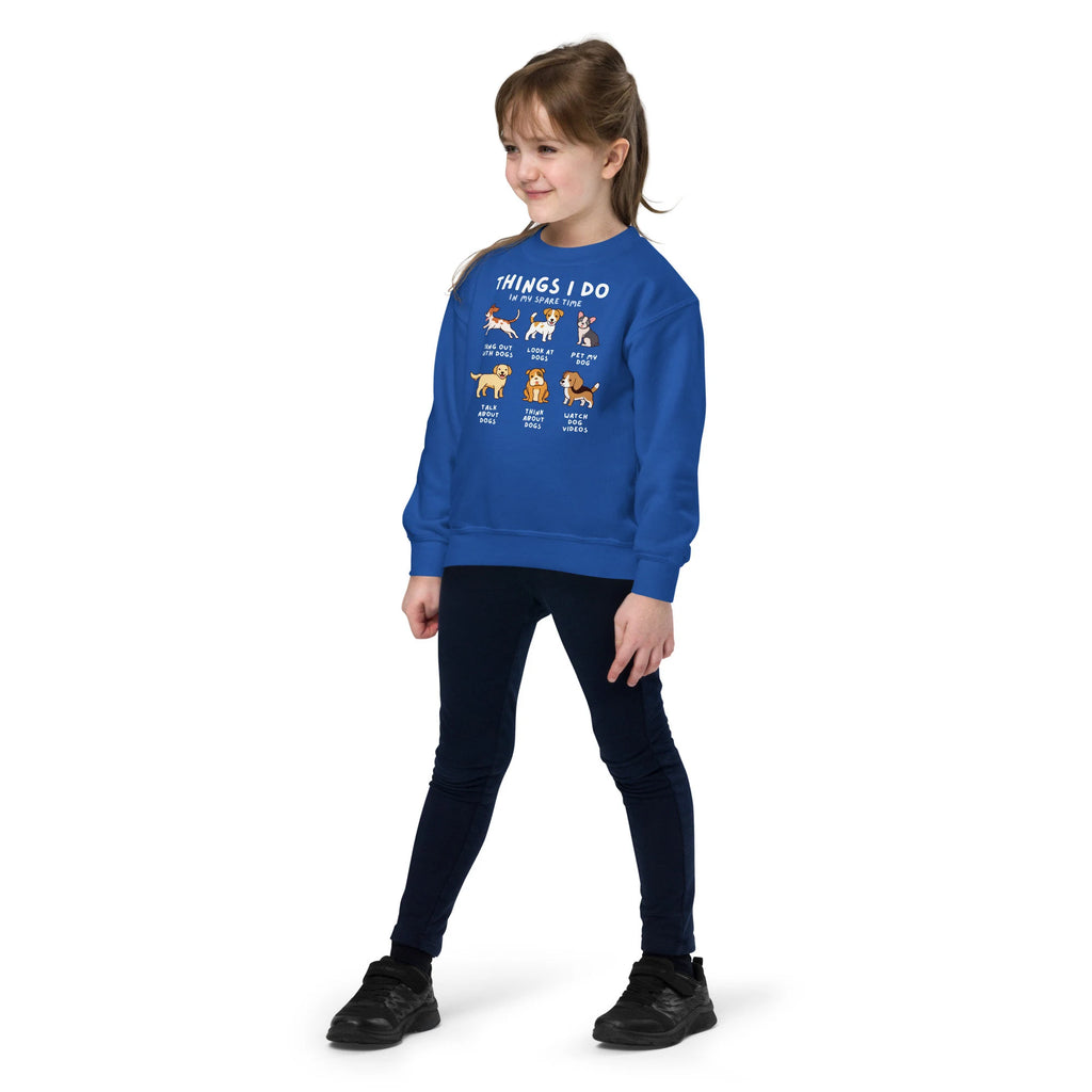 A child wearing a blue sweatshirt with text and illustrations of dogs, indicating favorite activities 'Things I Do In My Spare Time'.