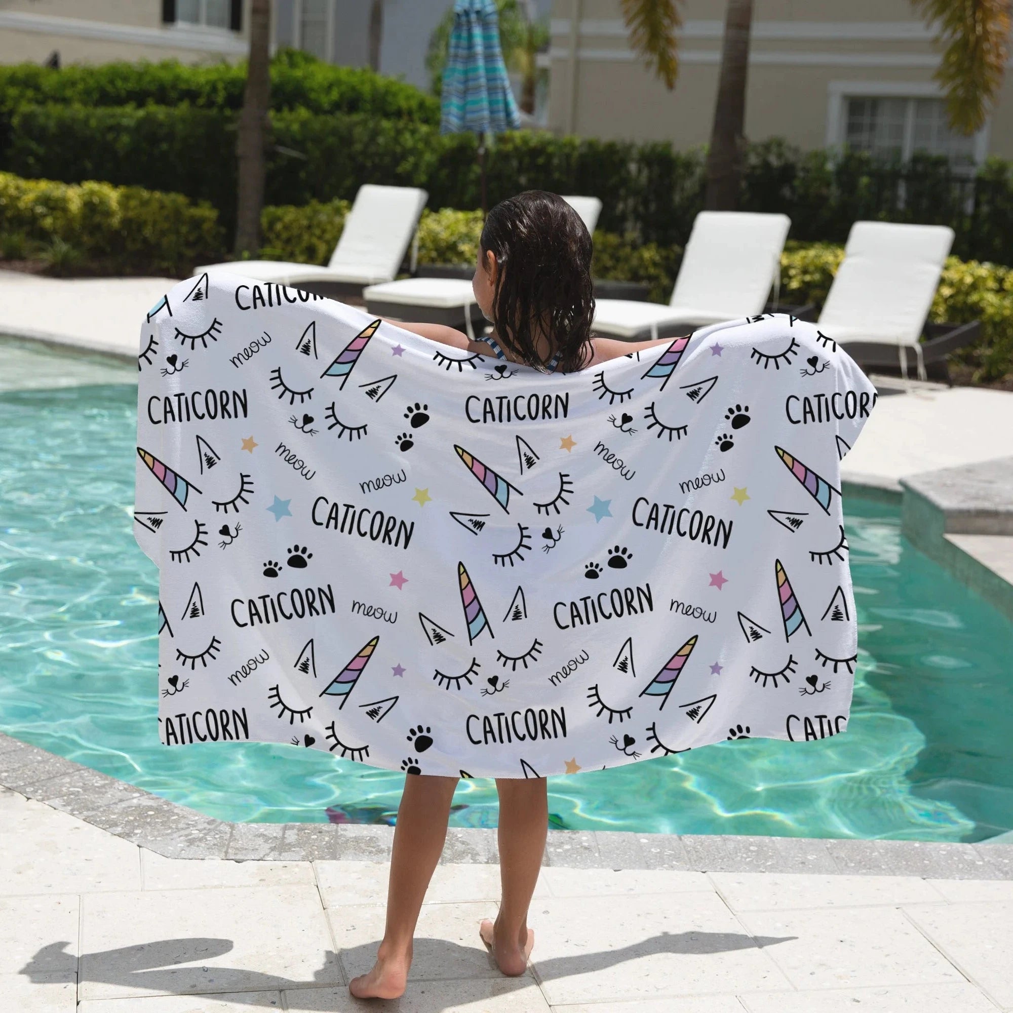 Girls caticorn towel featuring white soft fabric with colorful unicorn horns black text and paw prints design