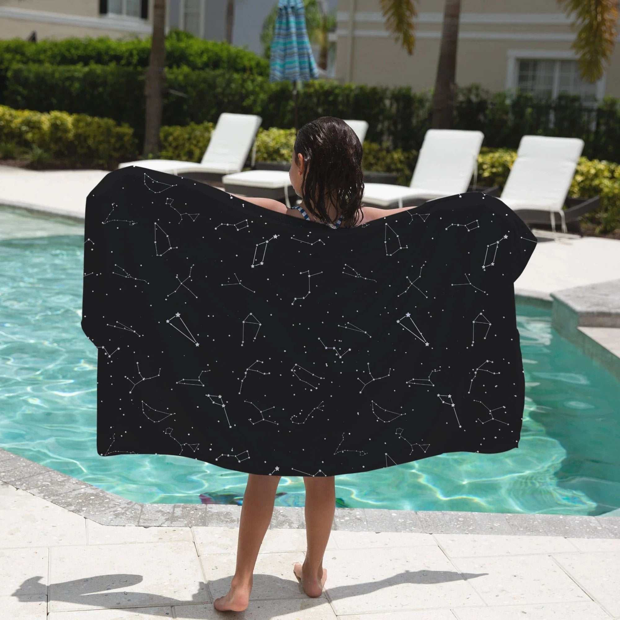 Black star map beach towel with white constellation outlines designed for kids featuring realistic constellation details