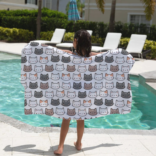 White towel with a repeating pattern of cute cartoon cat faces in gray white and beige for girls