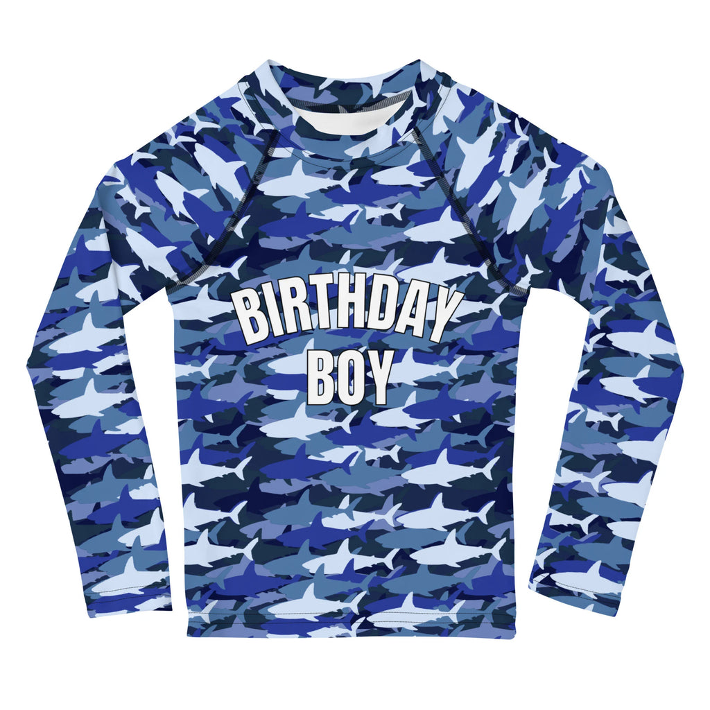 Blue and white shark camouflage long sleeve rash guard with birthday boy printed in bold white letters on chest