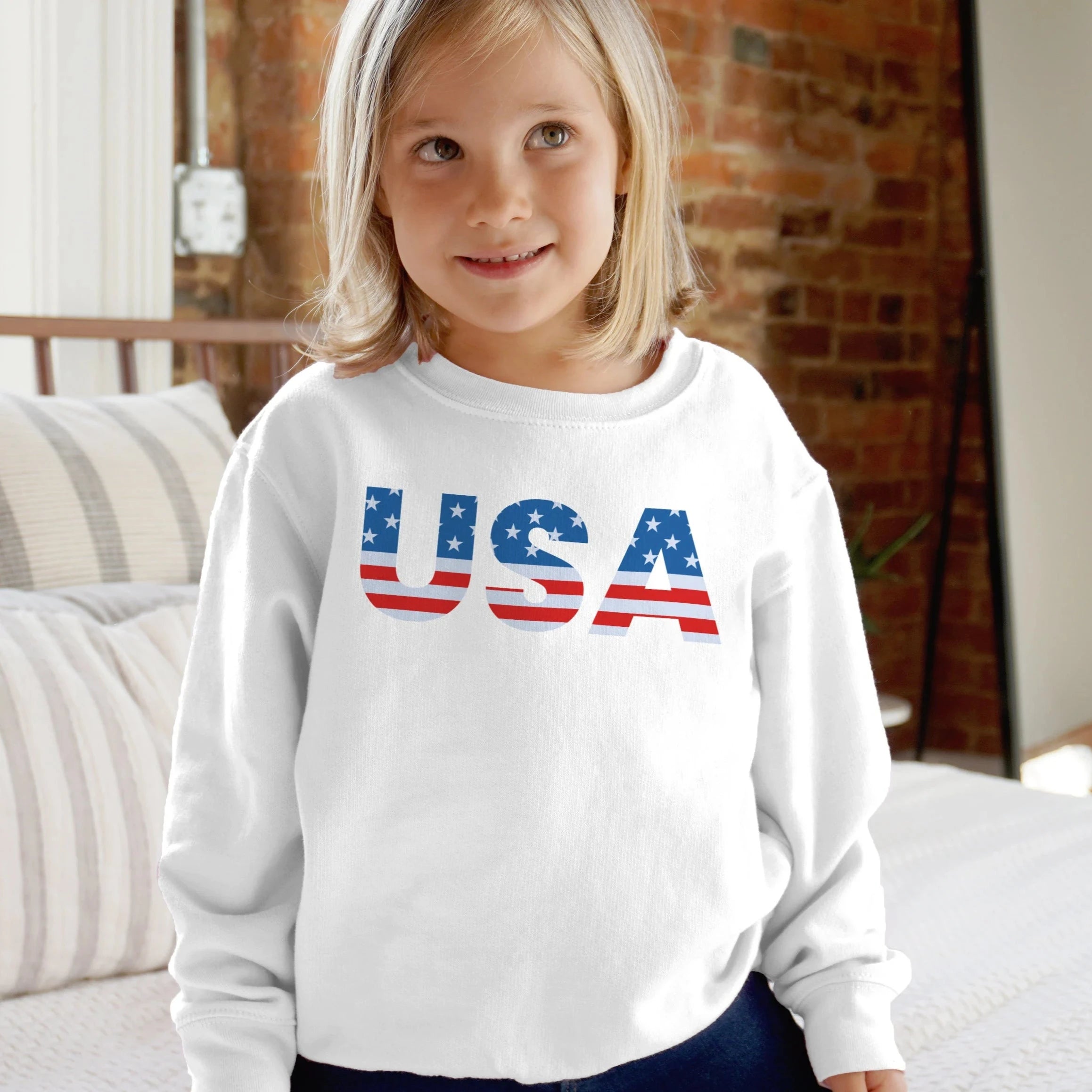 White long-sleeved kids usa sweatshirt with red white and blue flag design printed across the chest