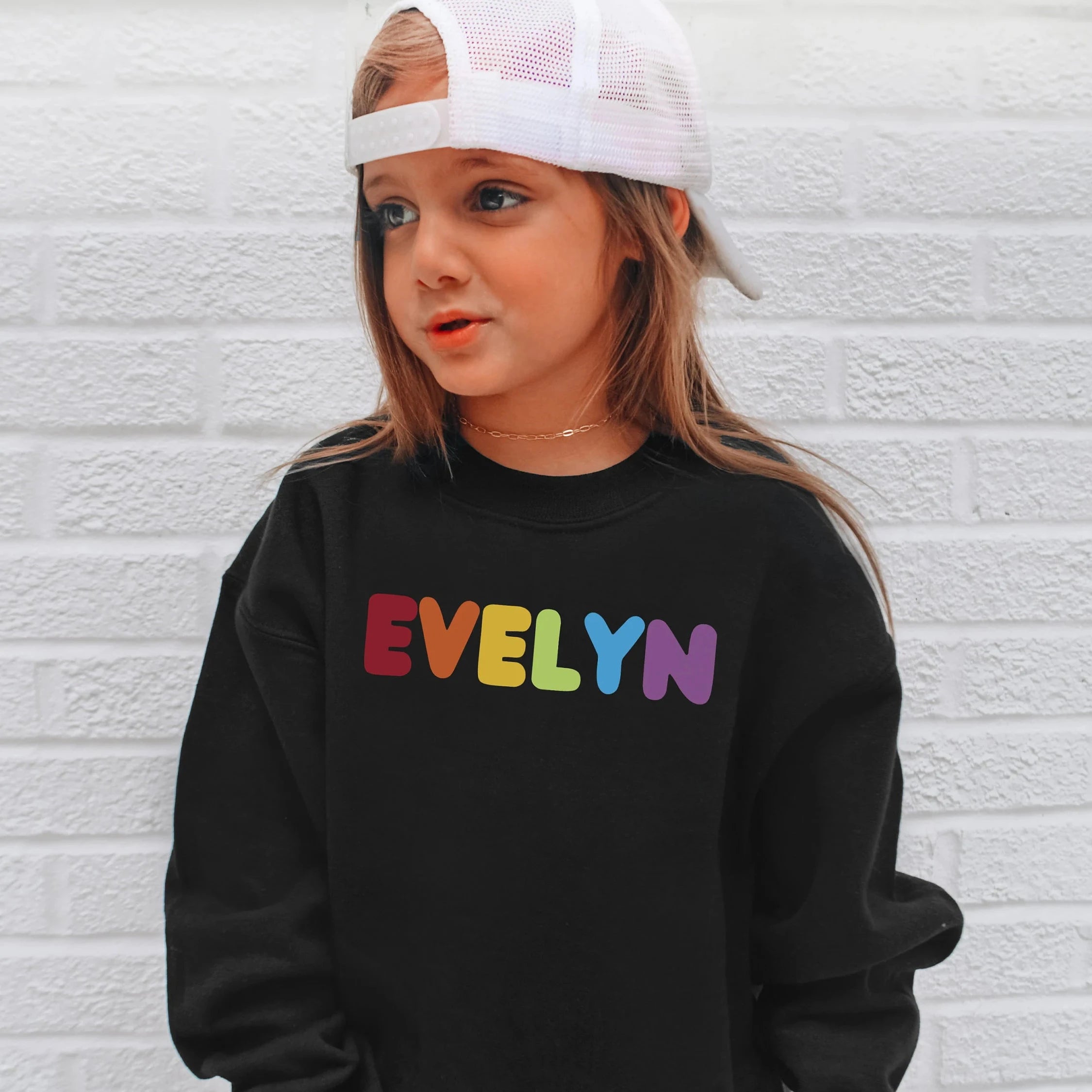 Black sweatshirt with evelyn printed in rainbow colors personalized kids apparel for girls custom name design