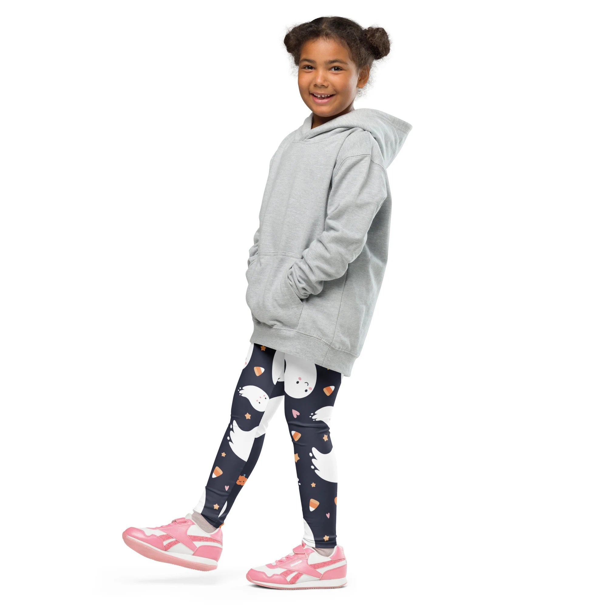 A child wearing kids ghost Halloween buttery soft dark navy leggings with white ghosts and pink candy corn prints