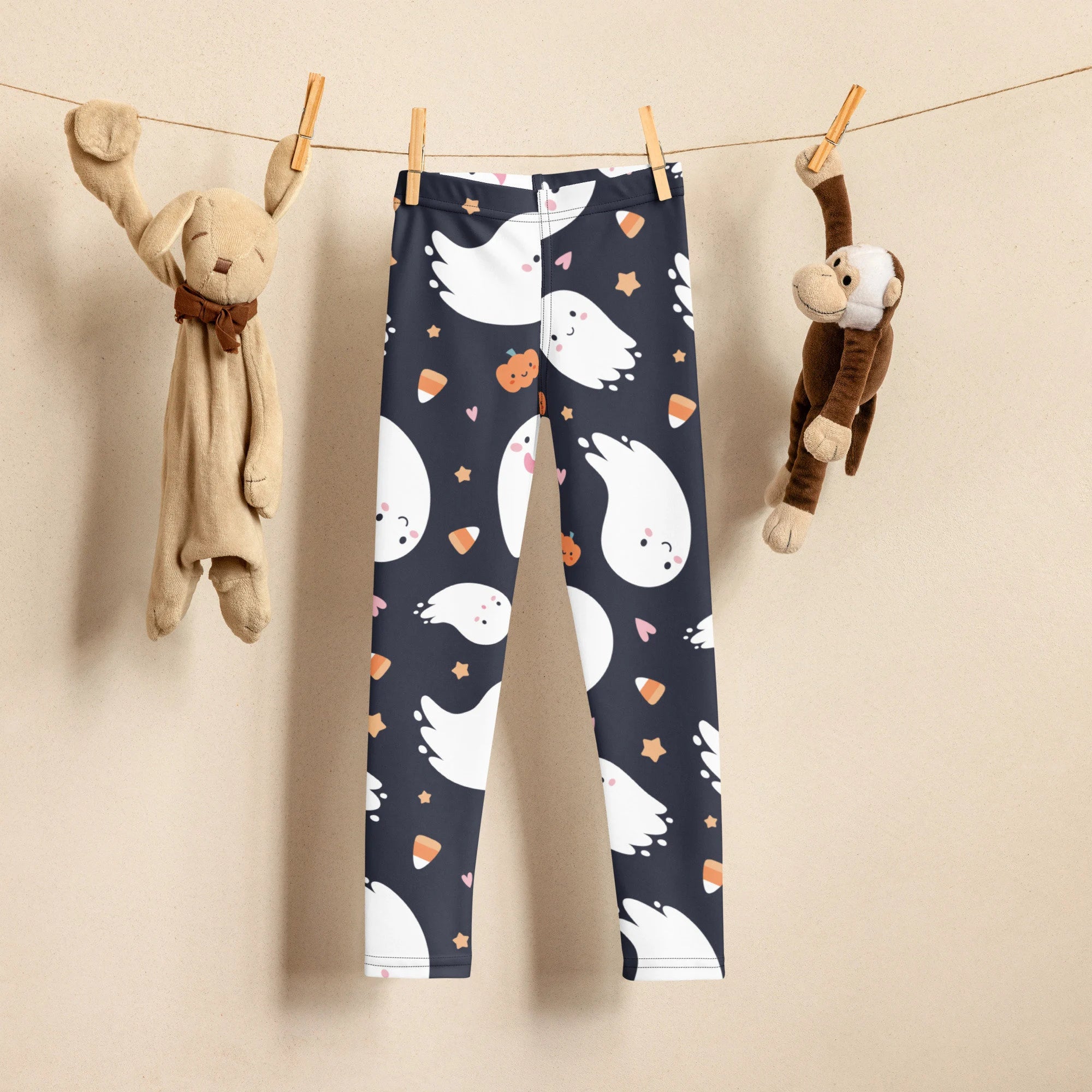 Dark blue kids ghost halloween buttery soft leggings with white cartoon ghosts orange candy corn and stars pattern