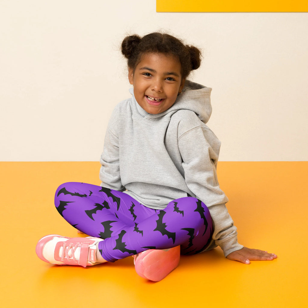 Kids purple buttery soft leggings with black bat patterns perfect for halloween wear