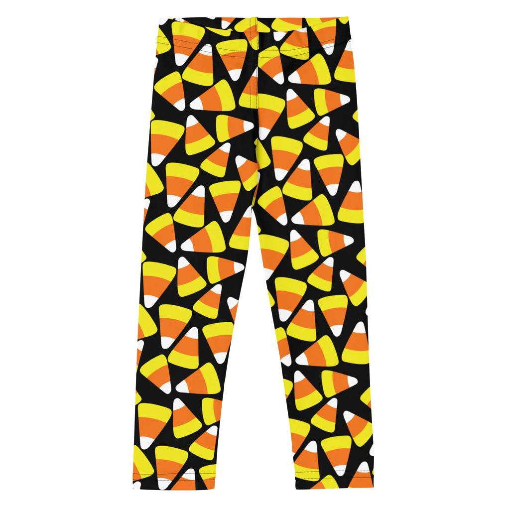 Kids candy corn buttery soft leggings in black featuring a vibrant pattern of orange yellow and white candy corn shapes