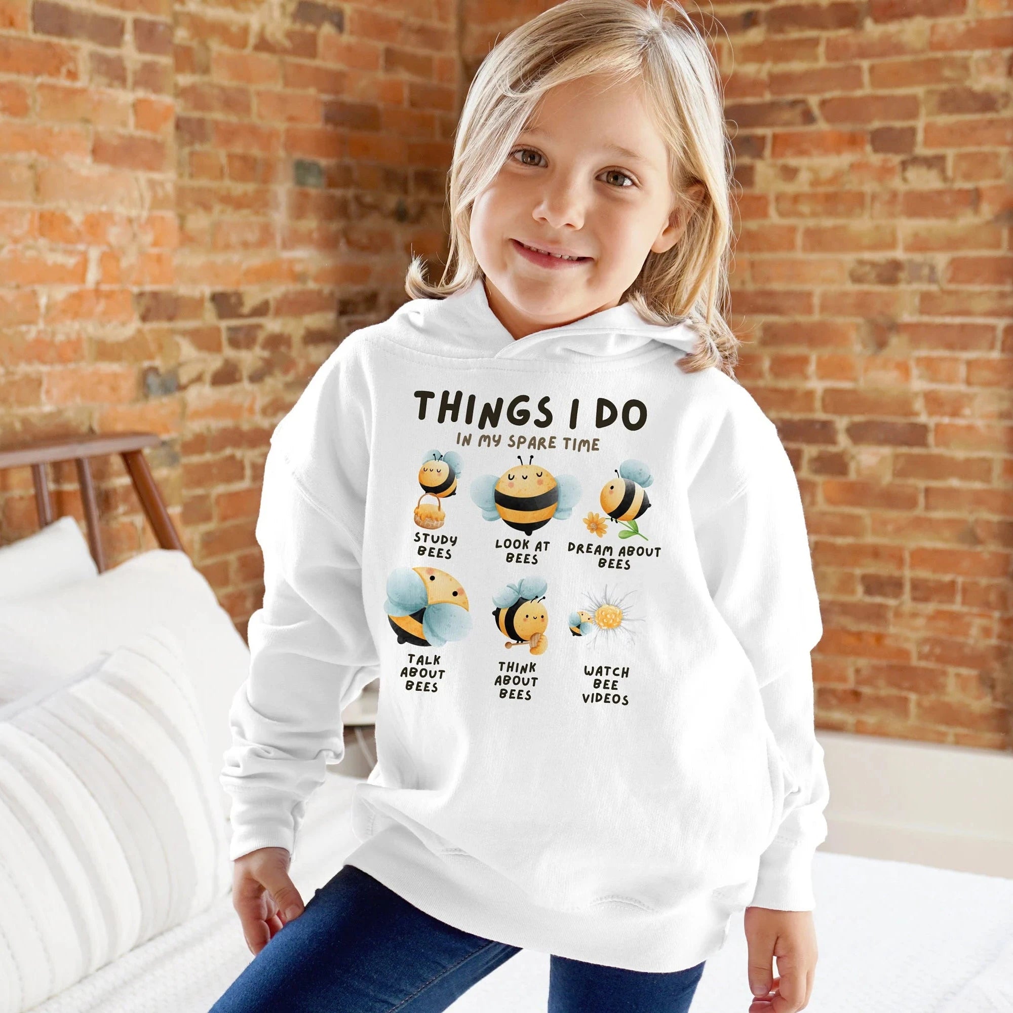 Kids white hoodie with cartoon bee illustrations and text things i do in my spare time on the front