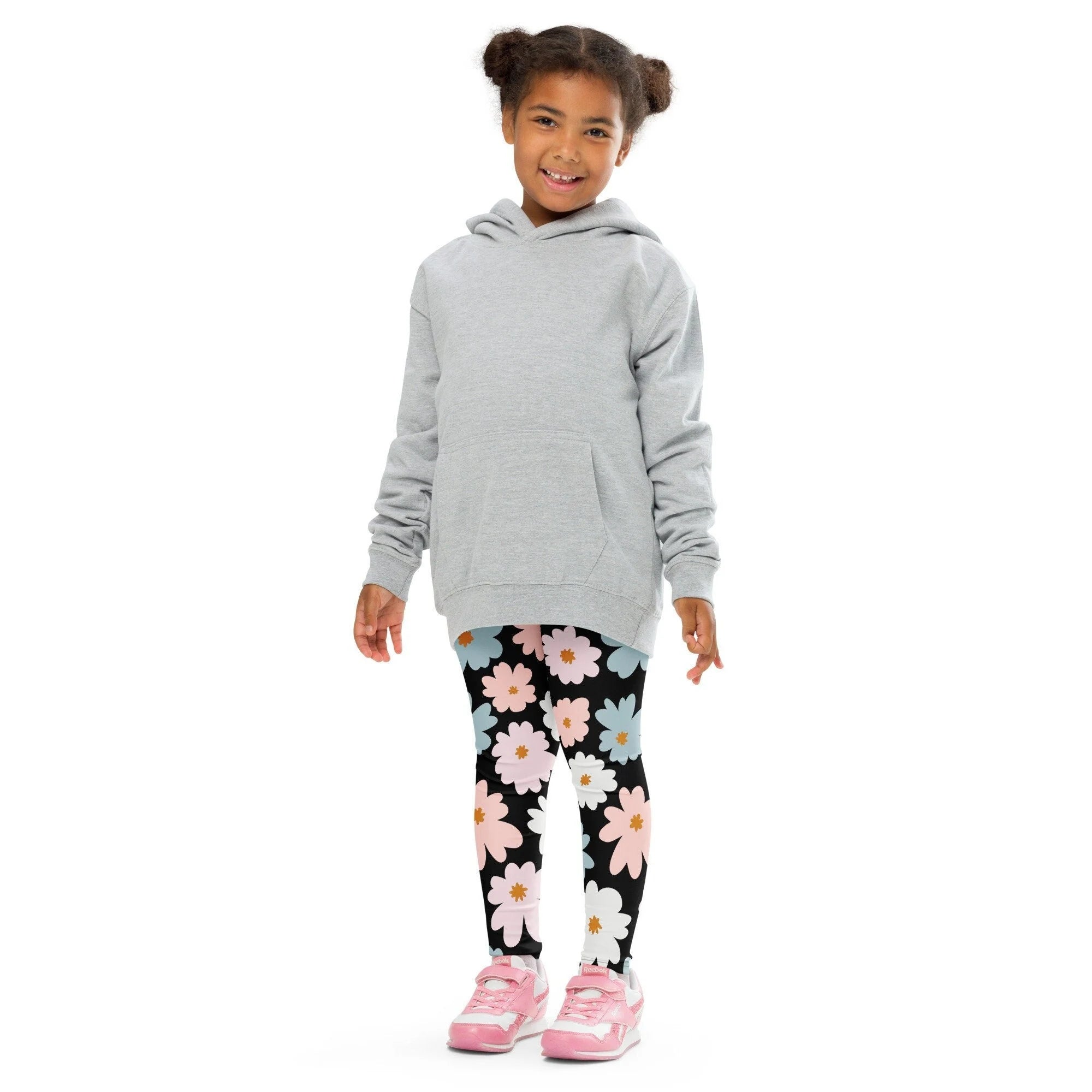 Gray hooded sweatshirt with front pocket and long sleeves paired with girls flower buttery soft leggings