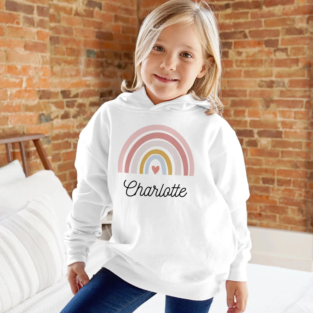 Girls custom name white hoodie with pastel rainbow and charlotte in black cursive across the chest