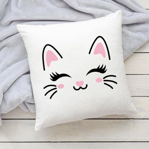 White square pillow featuring a cute cartoon cat face with pink ears and blush cheeks perfect for girls rooms