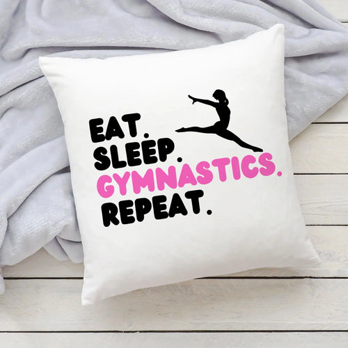 White pillow with black and pink eat text in girls eat sleep gymnastics repeat design for decor and comfort