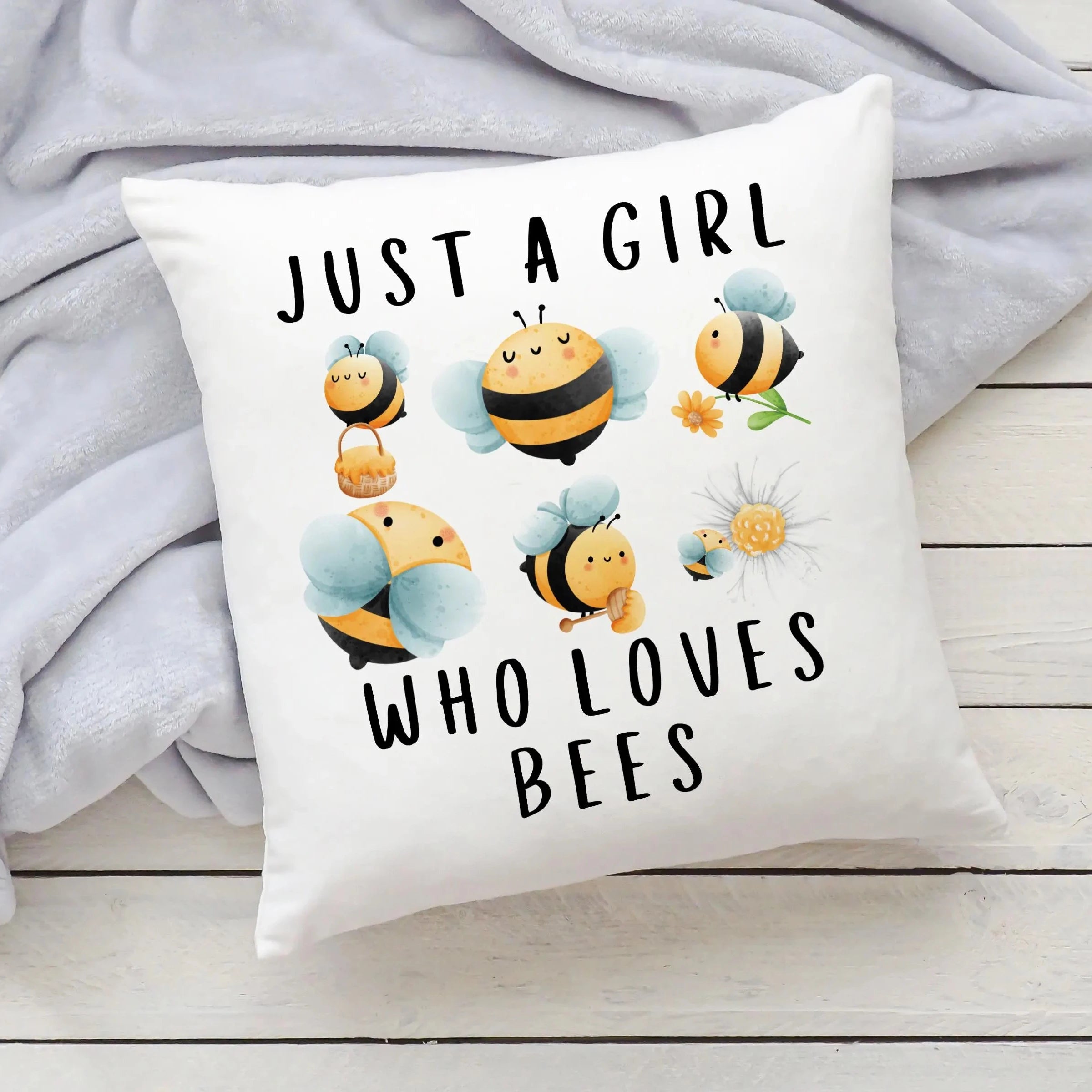 White throw pillow featuring cute cartoon bees with yellow and black stripes and just a girl who loves bees text