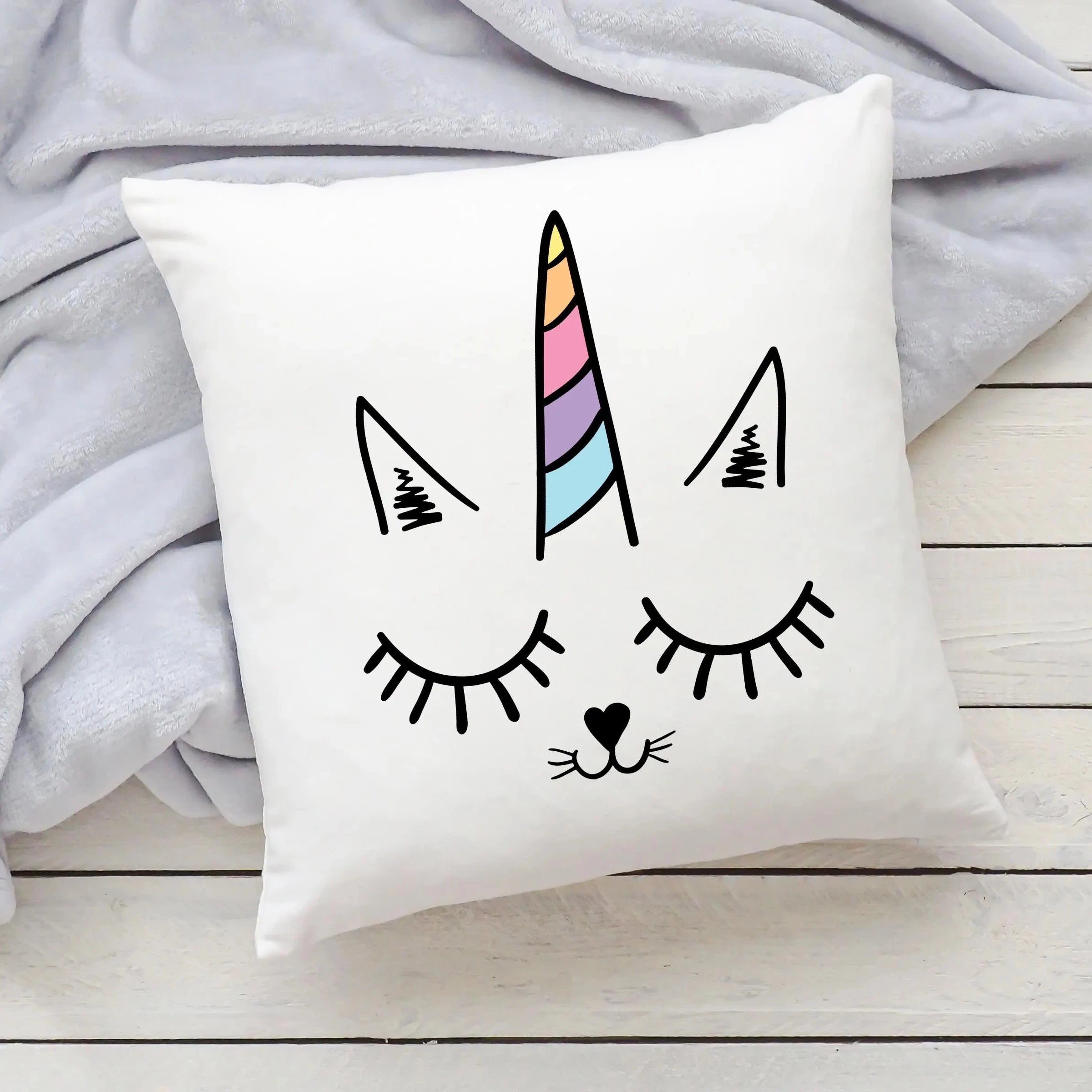 White square girls caticorn pillow with cute cartoon cat face closed eyes long lashes and rainbow unicorn horn