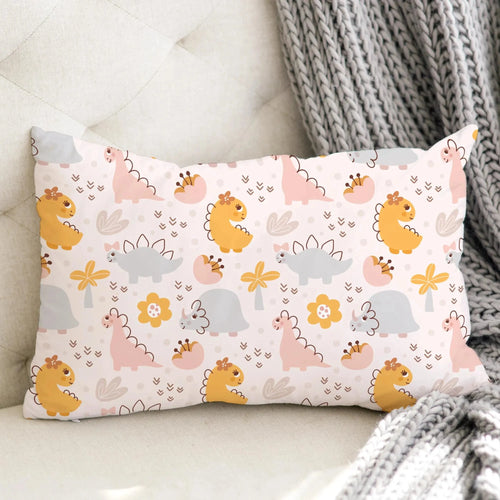 Girls floral dinosaur pillowcase with pastel cartoon dinosaurs flowers and eggs on a light pink rectangular pillow