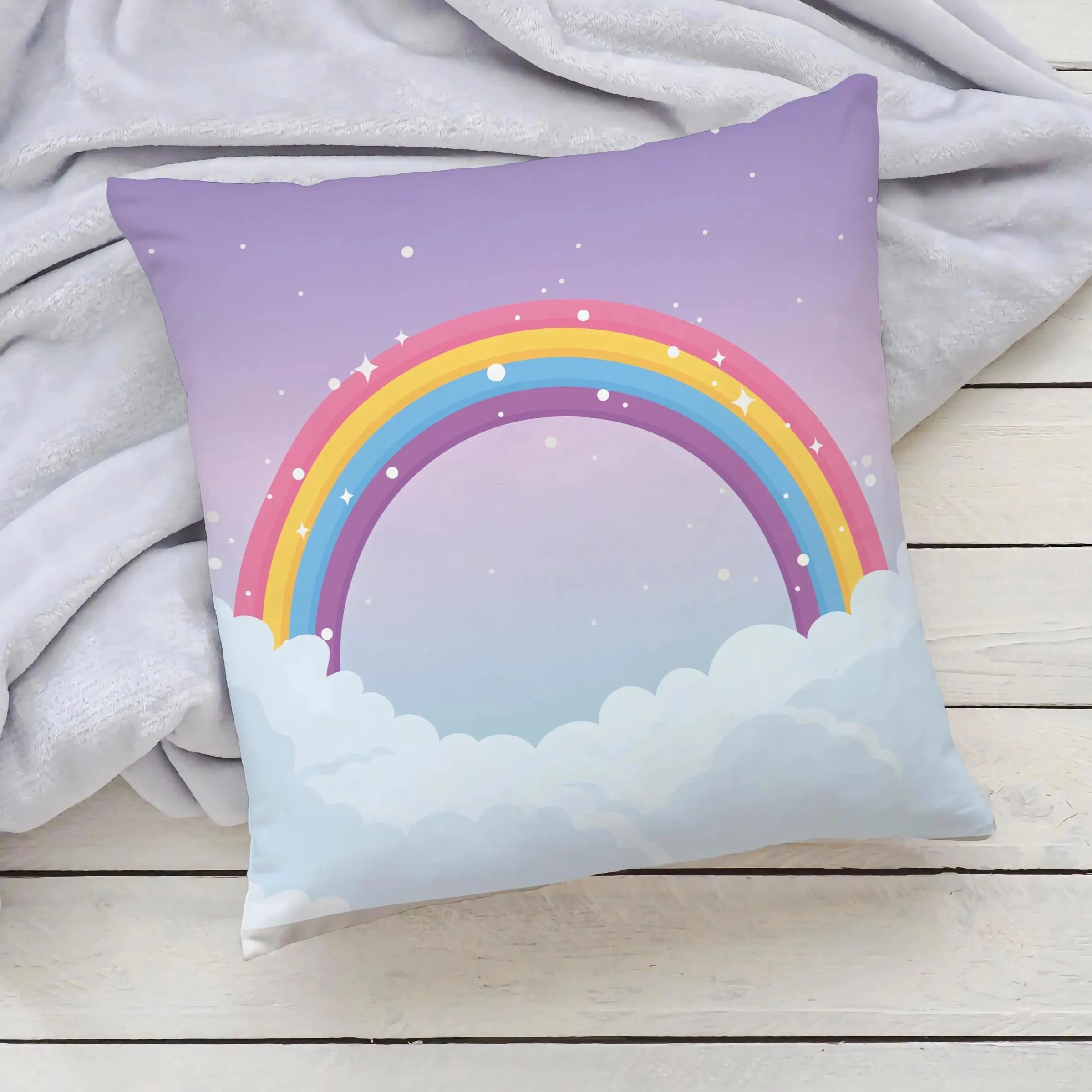 Pastel purple girls rainbow and clouds pillow featuring a colorful rainbow over fluffy clouds on a starry sky background