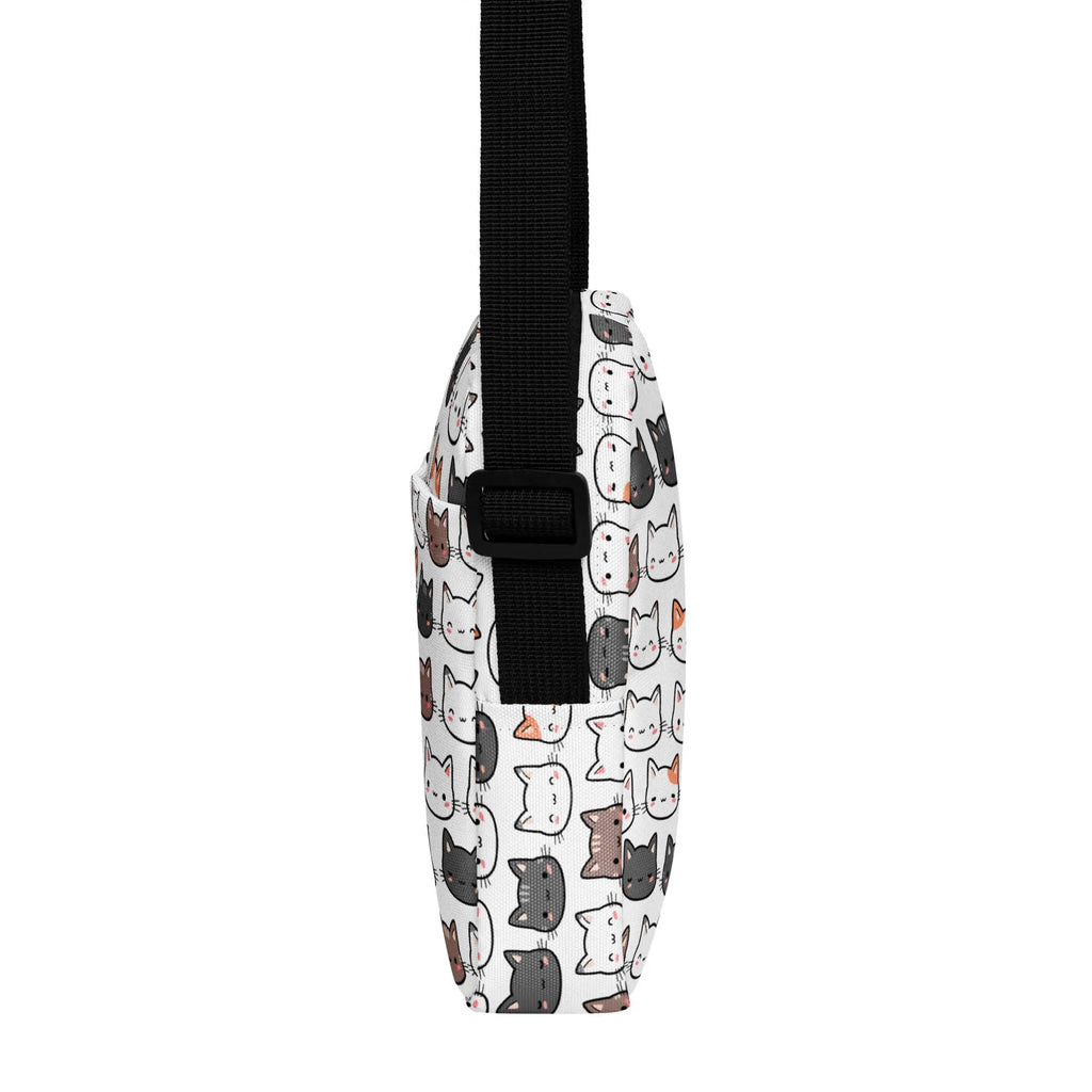 Girls cat crossbody purse in white featuring a playful pattern of cartoon cats in black gray and brown with pink accents