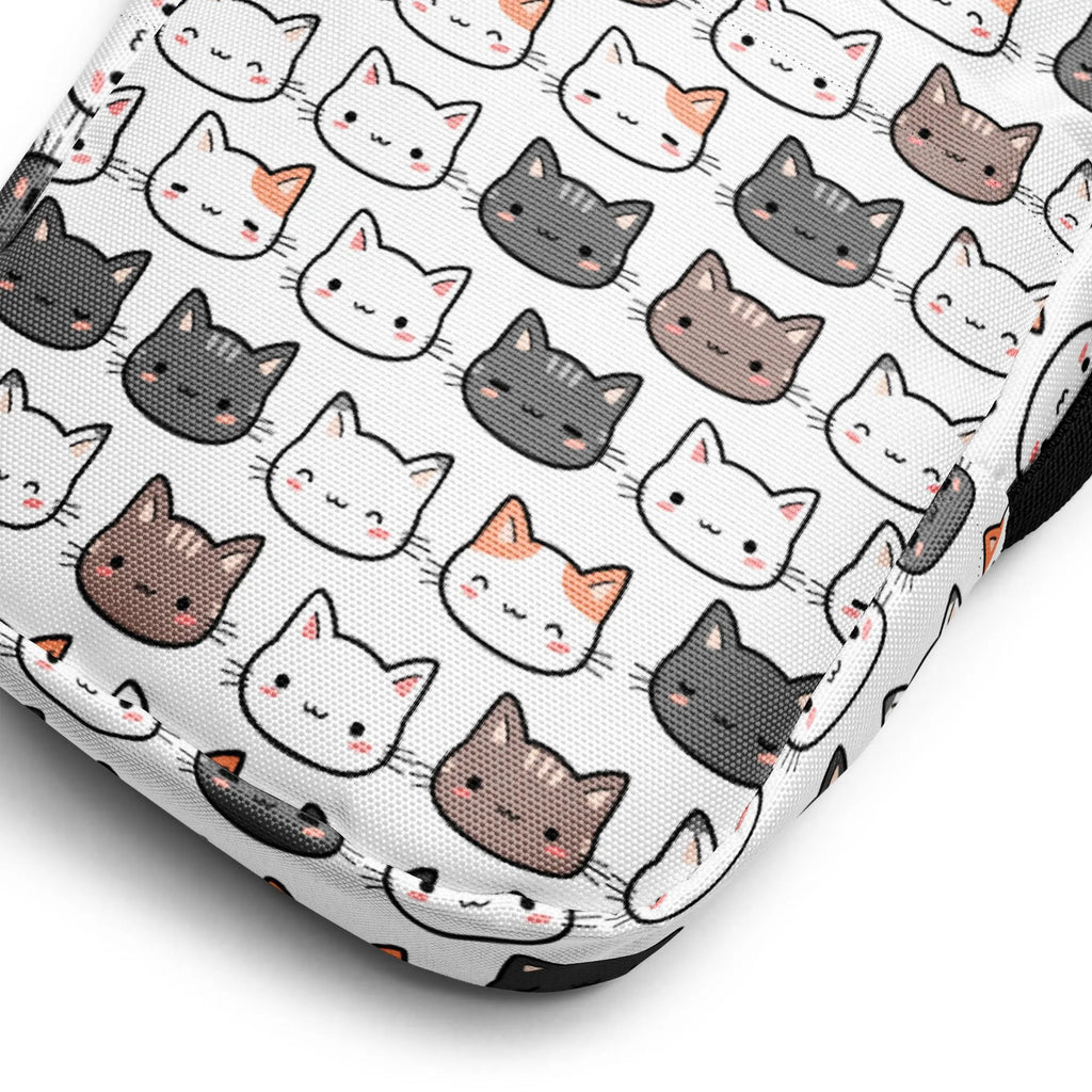 White fabric girls cat crossbody purse with repeating cute cartoon cat faces in black gray white and brown