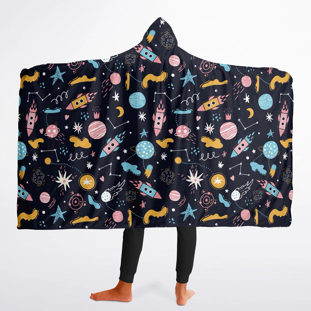 A cozy black hooded kids wearable blanket with colorful space-themed rockets, planets, stars, and constellations pattern