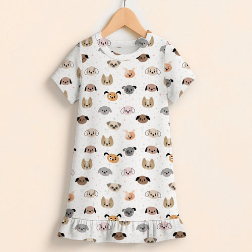 Girls dog face short sleeve ruffle hem dress in white featuring colorful cartoon dog faces on a wooden hanger