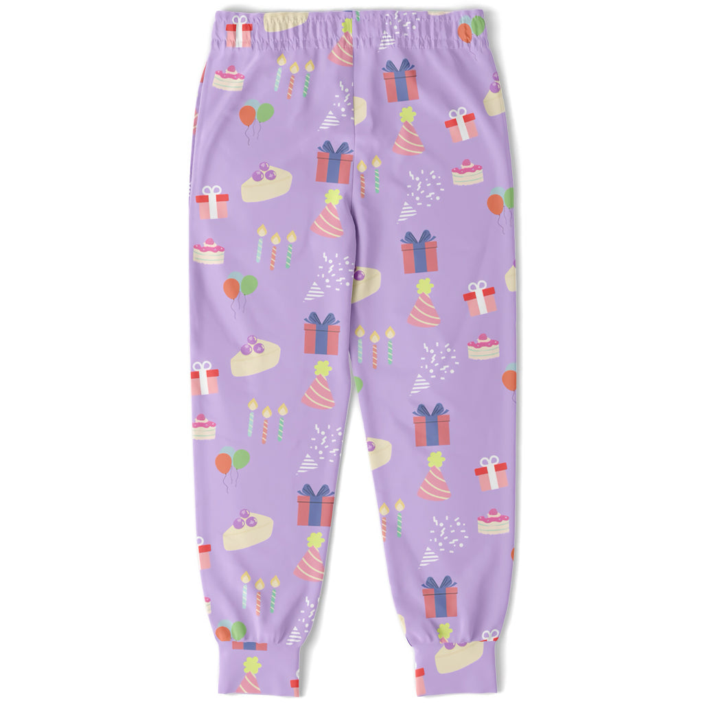 Girls birthday jogger pants in purple with a playful pattern of colorful gifts cakes hats and balloons