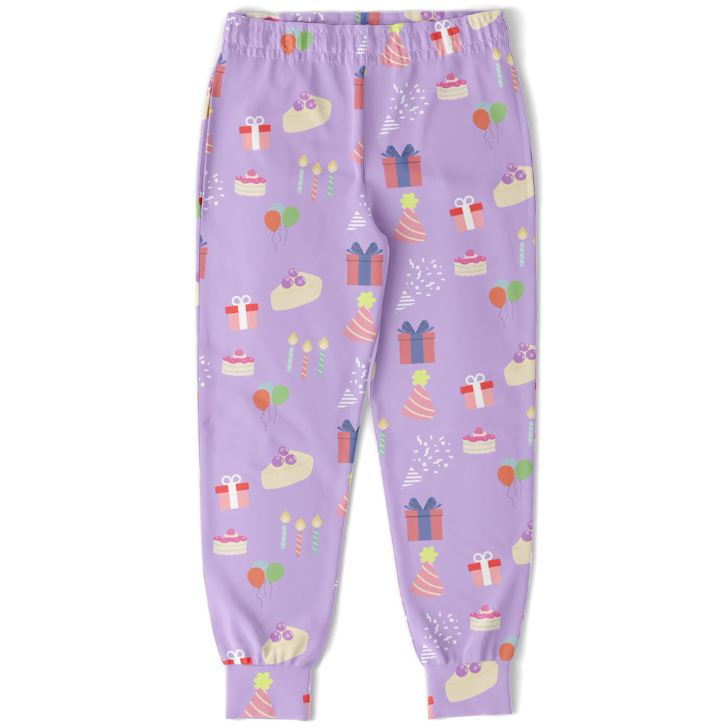 Girls birthday jogger pants in purple with playful pastel birthday cakes gifts balloons and party hats pattern