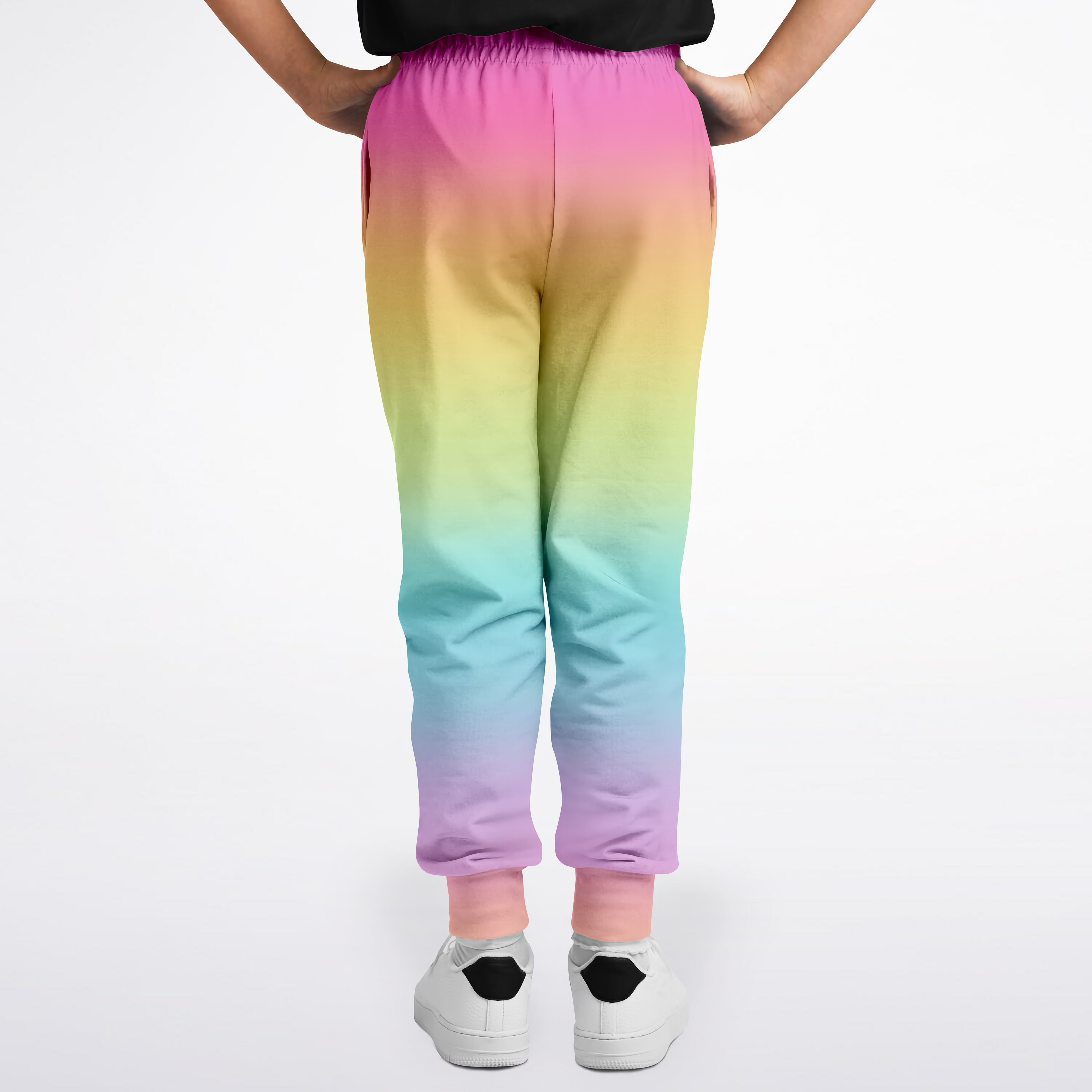 Girls bright rainbow jogger pants with soft stretchy fabric and elastic waistband in a vibrant rainbow gradient