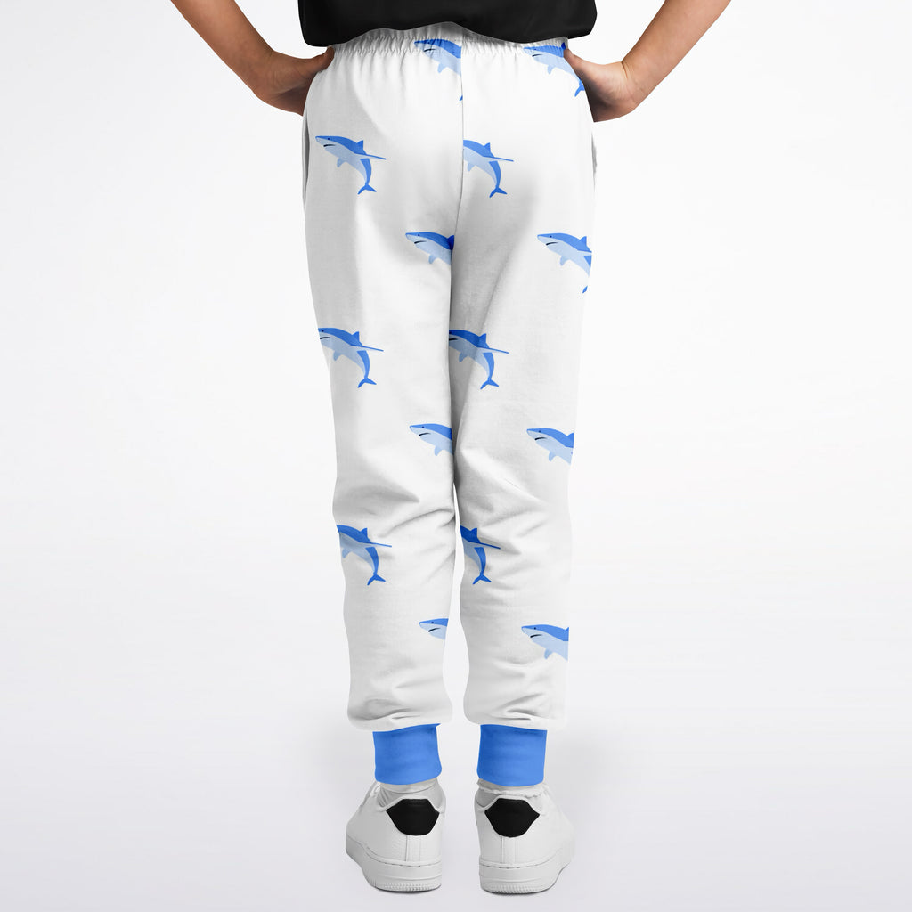 Kids shark jogger pants in white with blue shark pattern and solid blue cuffs for comfortable everyday wear