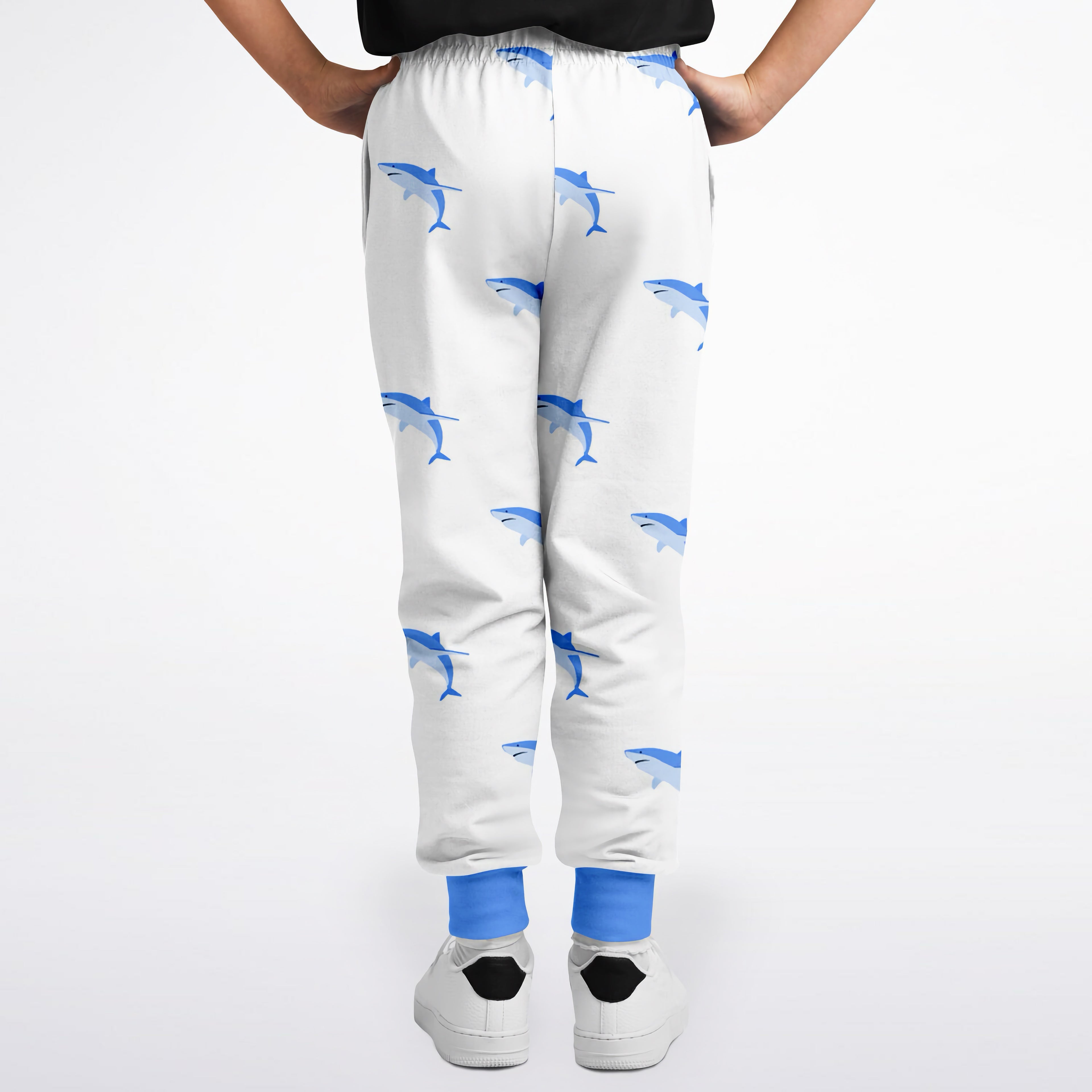 Kids shark jogger pants in white with blue shark pattern and solid blue cuffs for comfortable everyday wear