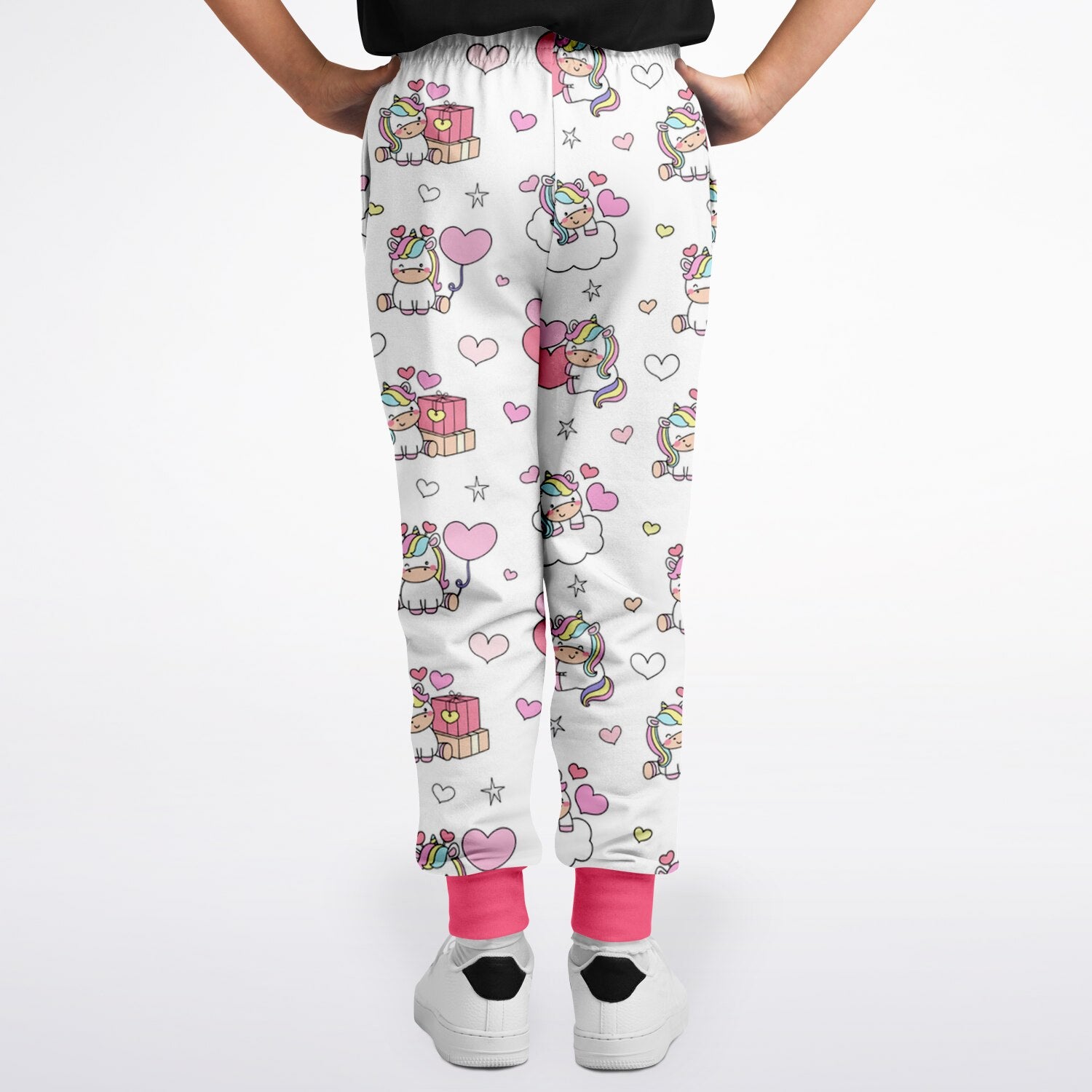 Girls unicorn birthday jogger pants in white with playful pink pastel unicorn hearts stars and bright pink cuffs