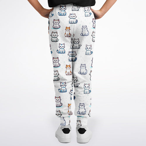 Girls cat pattern jogger pants in white featuring a playful cartoon cat print in white gray orange and blue colors