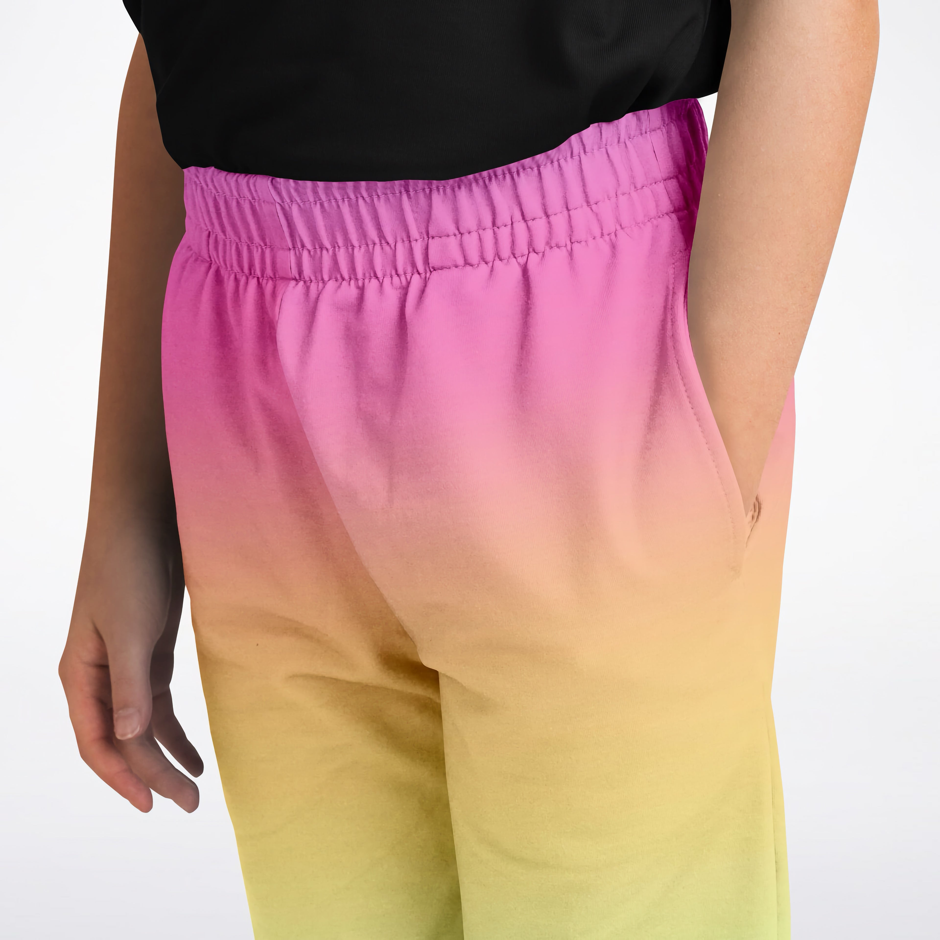 Girls bright rainbow jogger pants in vibrant magenta to yellow gradient with smooth flowing fabric