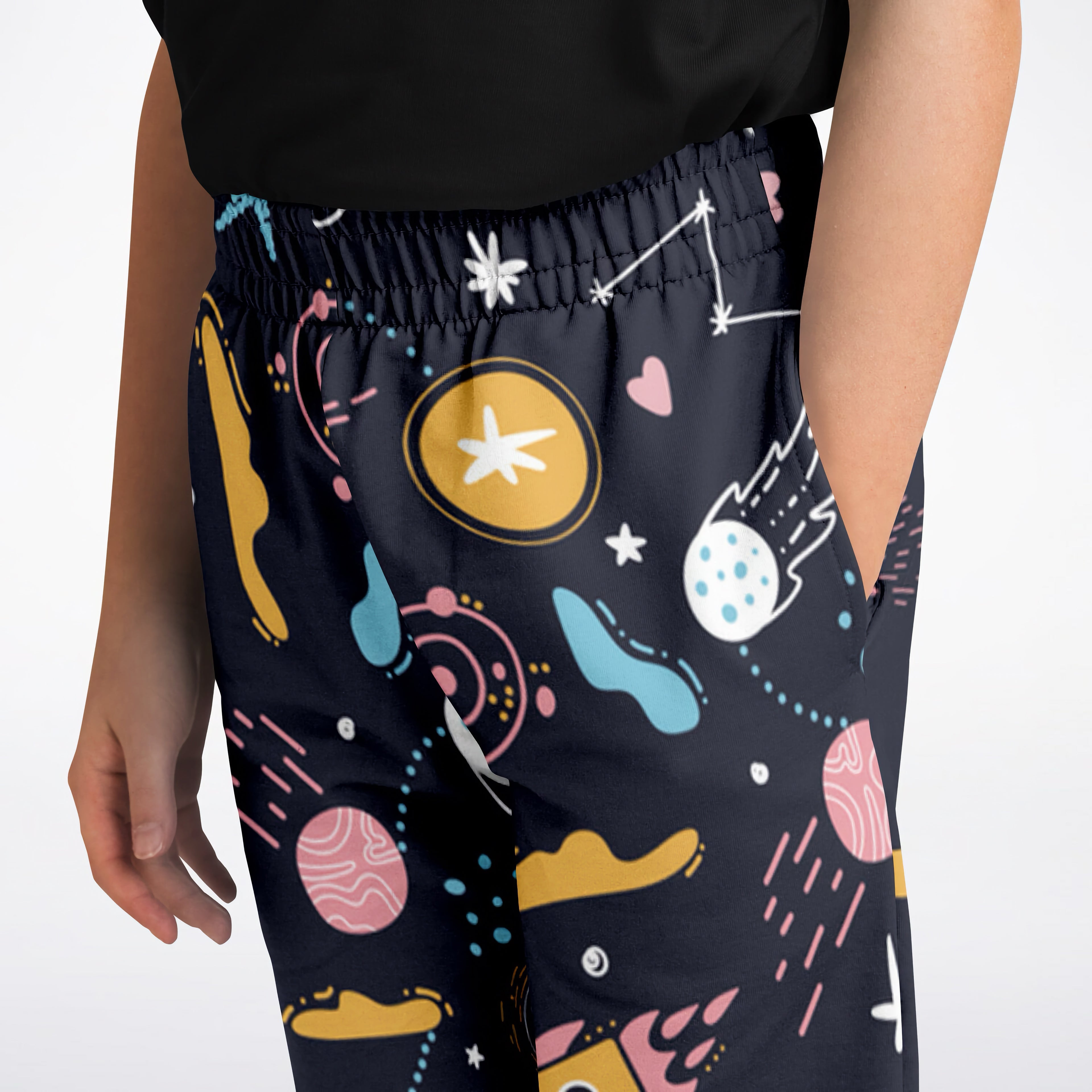 Kids outer space jogger pants in dark blue with vibrant yellow pink teal and white planet star and comet pattern