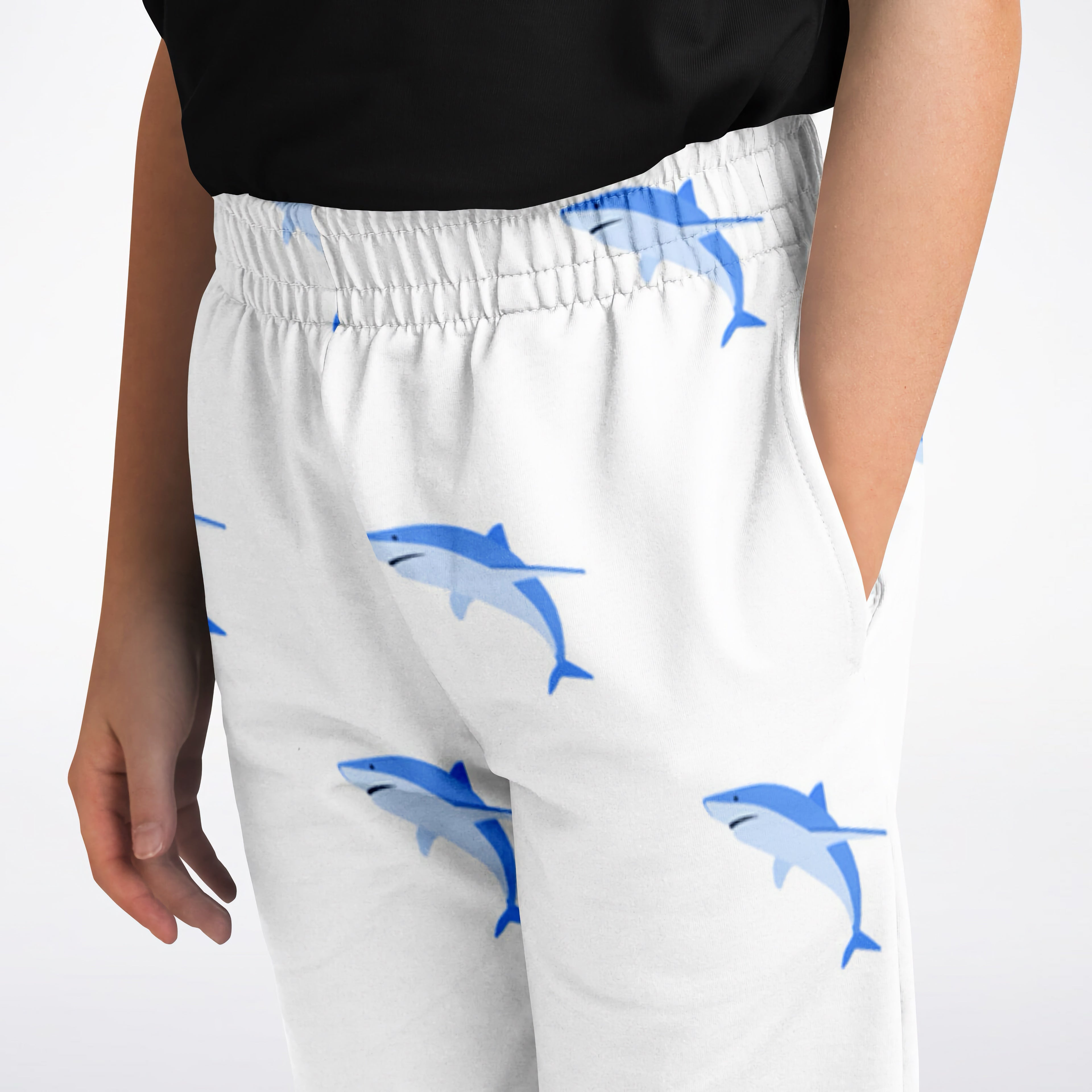 Kids shark jogger pants in white cotton with playful blue shark patterns suitable for active wear