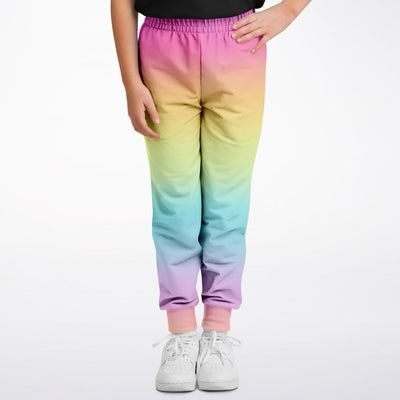 Girls bright rainbow jogger pants with a soft elastic waistband ribbed cuffs and vibrant gradient colors
