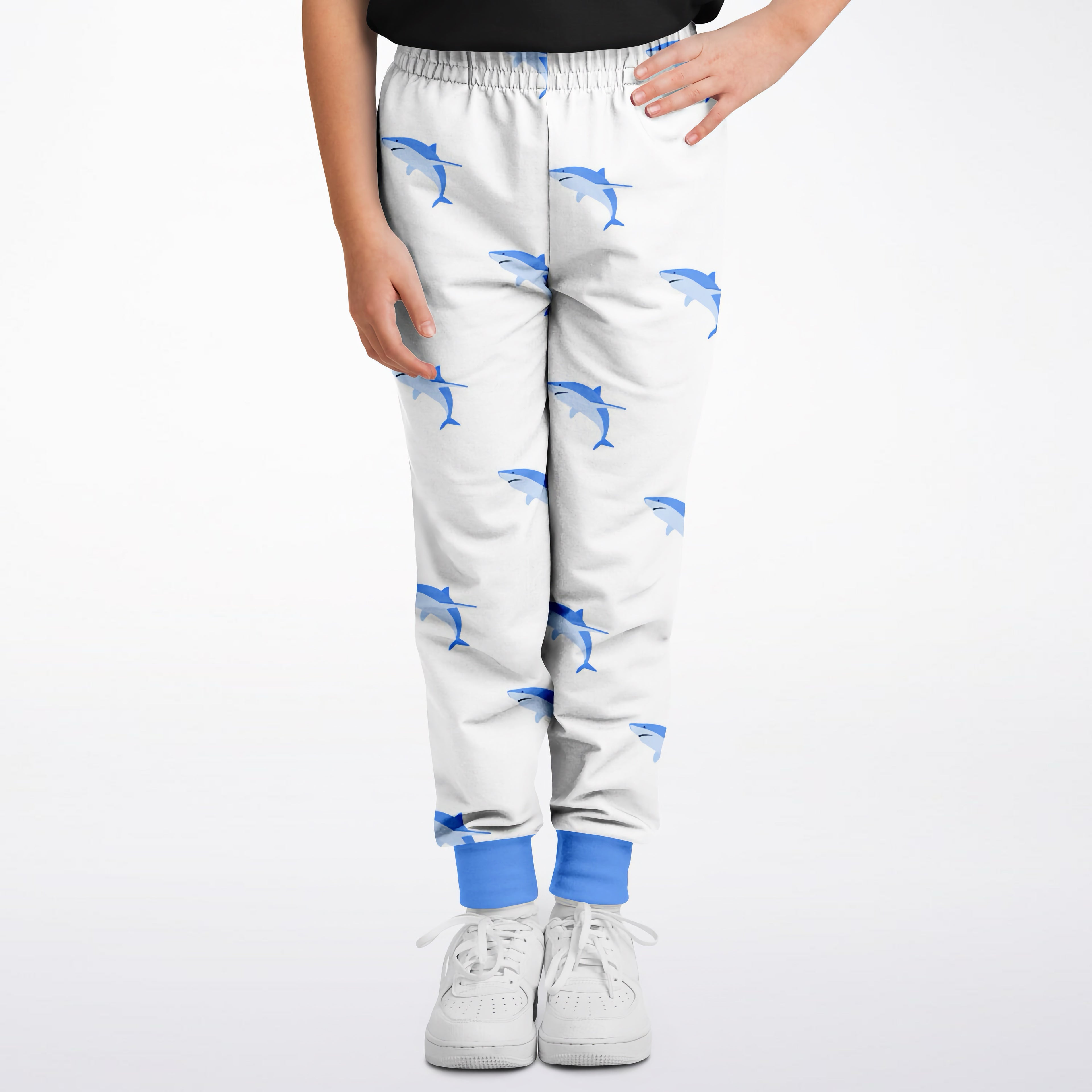 Kids shark jogger pants in white with blue dolphin pattern and solid blue cuffs perfect for casual wear