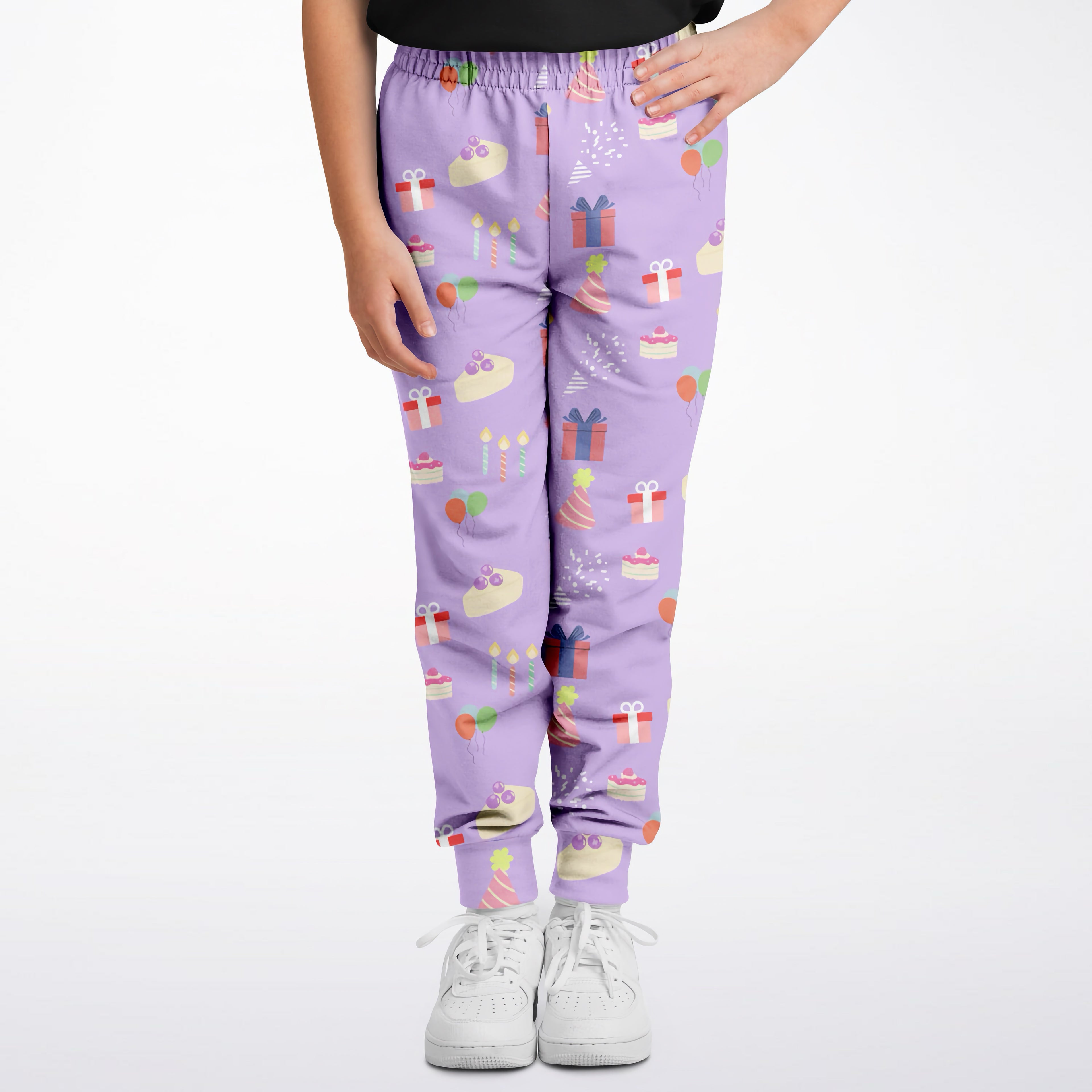 Girls birthday jogger pants in purple with playful pastel birthday cakes gifts and balloons pattern for kids