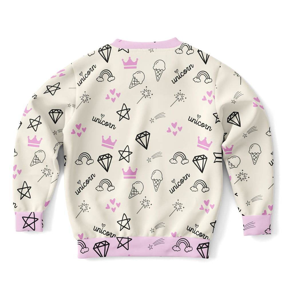 Cream-colored girls magical unicorn sweatshirt with playful black and pink prints in cozy cotton fleece fabric